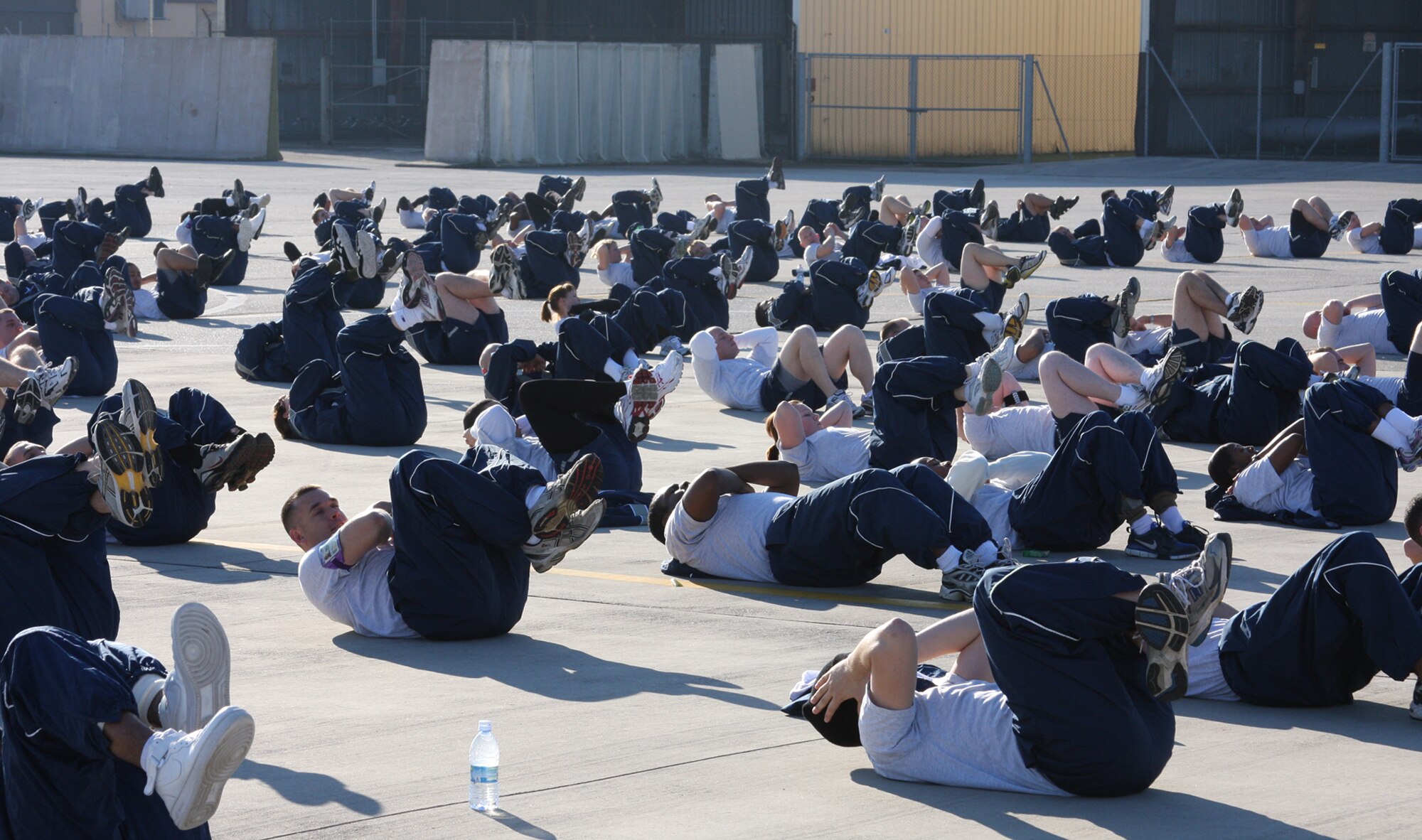 Members of the 31st Aircraft Maintenance Squadron do sit-ups as part of Air Force Wingman Day Dec. 8. Airmen from across the 31st Fighter Wing took time off of their daily work schedules to strenghten unit morale, improve co-worker relationships and focus on key Air Force issues including suicide prevention and sexual assault prevention. Activities included an Airmen's call, unit commanders' calls, and unit physical training sessions. (U.S. Air Force photo/Master Sgt. Christopher Sawaryn)