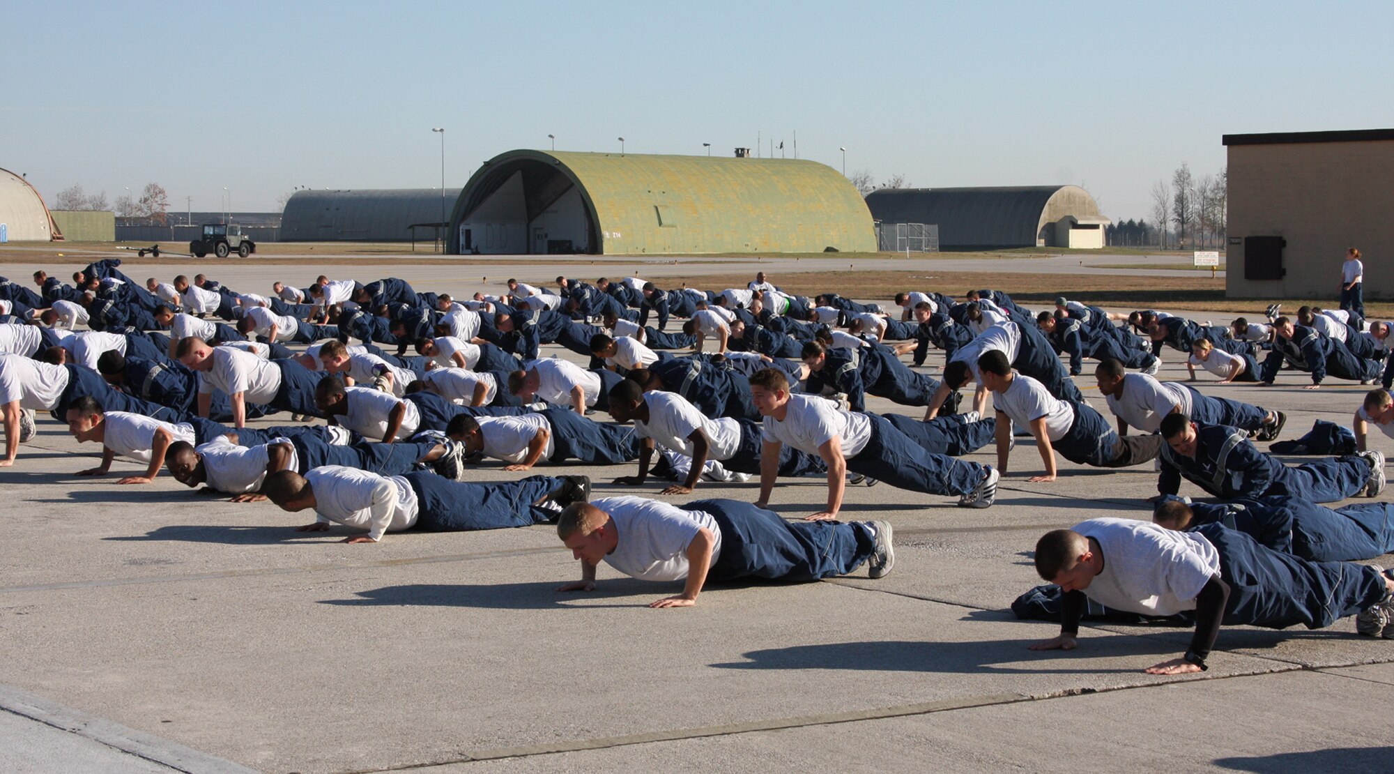 Members of the 31st Aircraft Maintenance Squadron do pushups as part of Air Force Wingman Day Dec. 8. Airmen from across the 31st Fighter Wing took time off of their daily work schedules to strenghten unit morale, improve co-worker relationships and focus on key Air Force issues including suicide prevention and sexual assault prevention. Activities included an Airmen's call, unit commanders' calls, and unit physical training sessions. (U.S. Air Force photo/Master Sgt. Christopher Sawaryn)