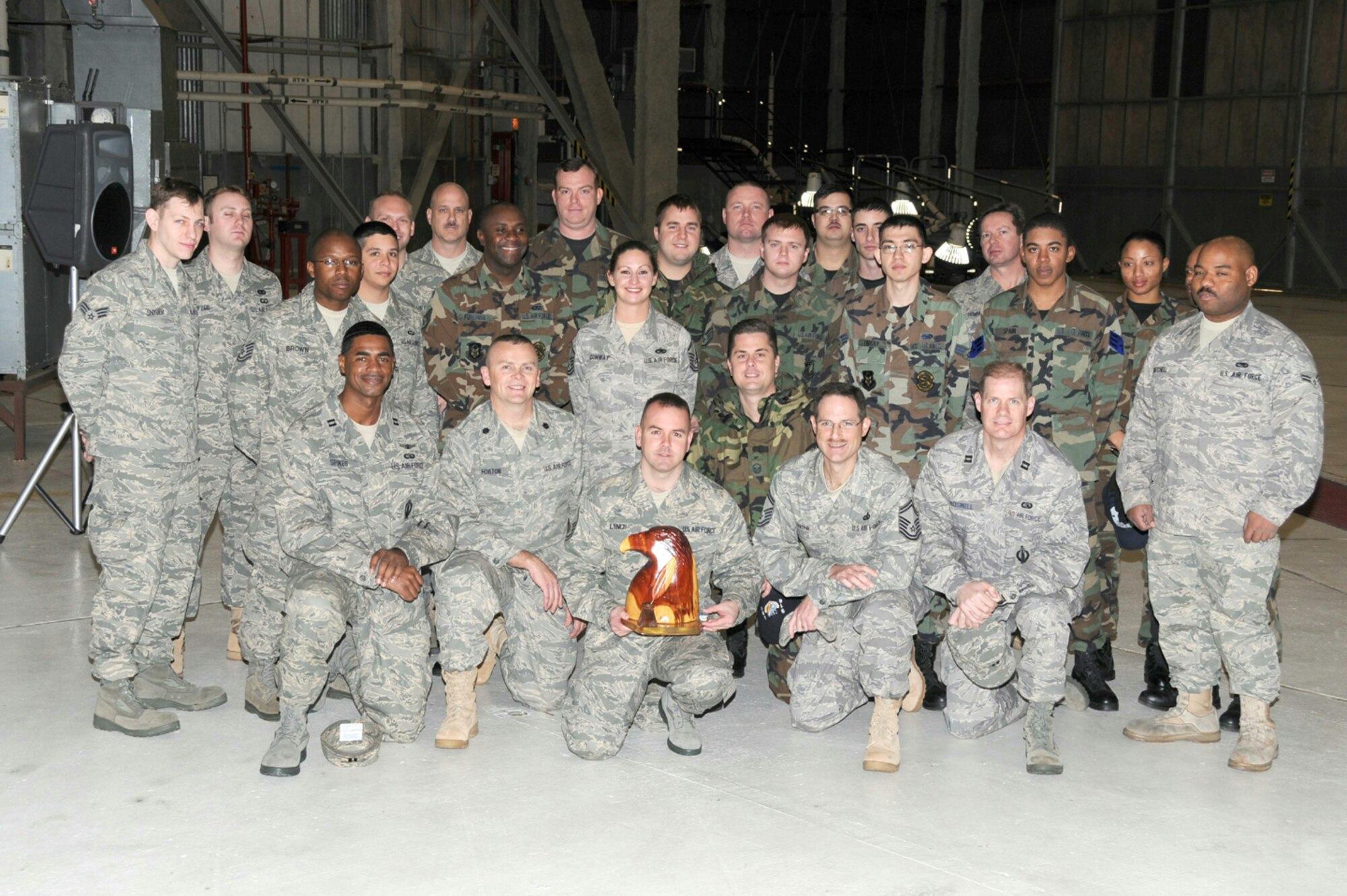 SEYMOUR JOHNSON AIR FORCE BASE, N.C. -- The 916th Communication Squadron stands together as the first recipient of the 916th Air Refueling Wing Unit Public Affairs Representative Program Award. The UPAR Award is presented to the squadron that contributes the most to the wing's public affairs program throughout the previous fiscal year. The award, which is one-of-a-kind, is an eagle head with a quill which represents the public affairs career field and was made by chainsaw artist Ted Scherer. The award was presented to Lt. Col. Tim Horton, squadron commander, during the December Wing Commander's Call.