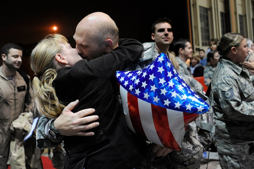 EGLIN AIR FORCE BASE, Fla. -- Lt. Col Jon Peck, 18th Flight Test Squadron commander, hugs and kisses his wife Michelle after returning home from a lengthy deployment, Dec. 9. (U.S. Air Force photo /Senior Airman Julianne Showalter)