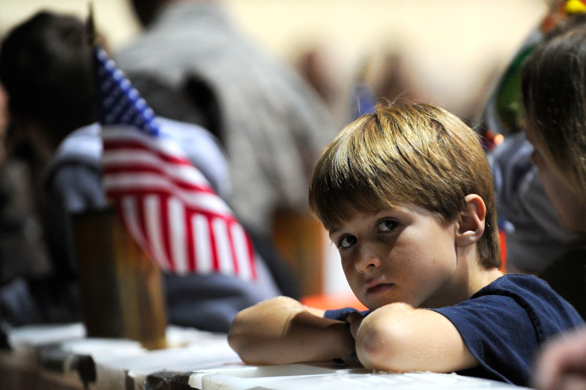 EGLIN AIR FORCE BASE, Fla. -- A young boy waits patiently for his dad to arrive during Operation Homecoming here, Dec. 9. Operation Homecoming gives friends and family the opportunity to greet loved ones who are returning from deployment as they depart the plane. (U.S. Air Force photo /Senior Airman Julianne Showalter)