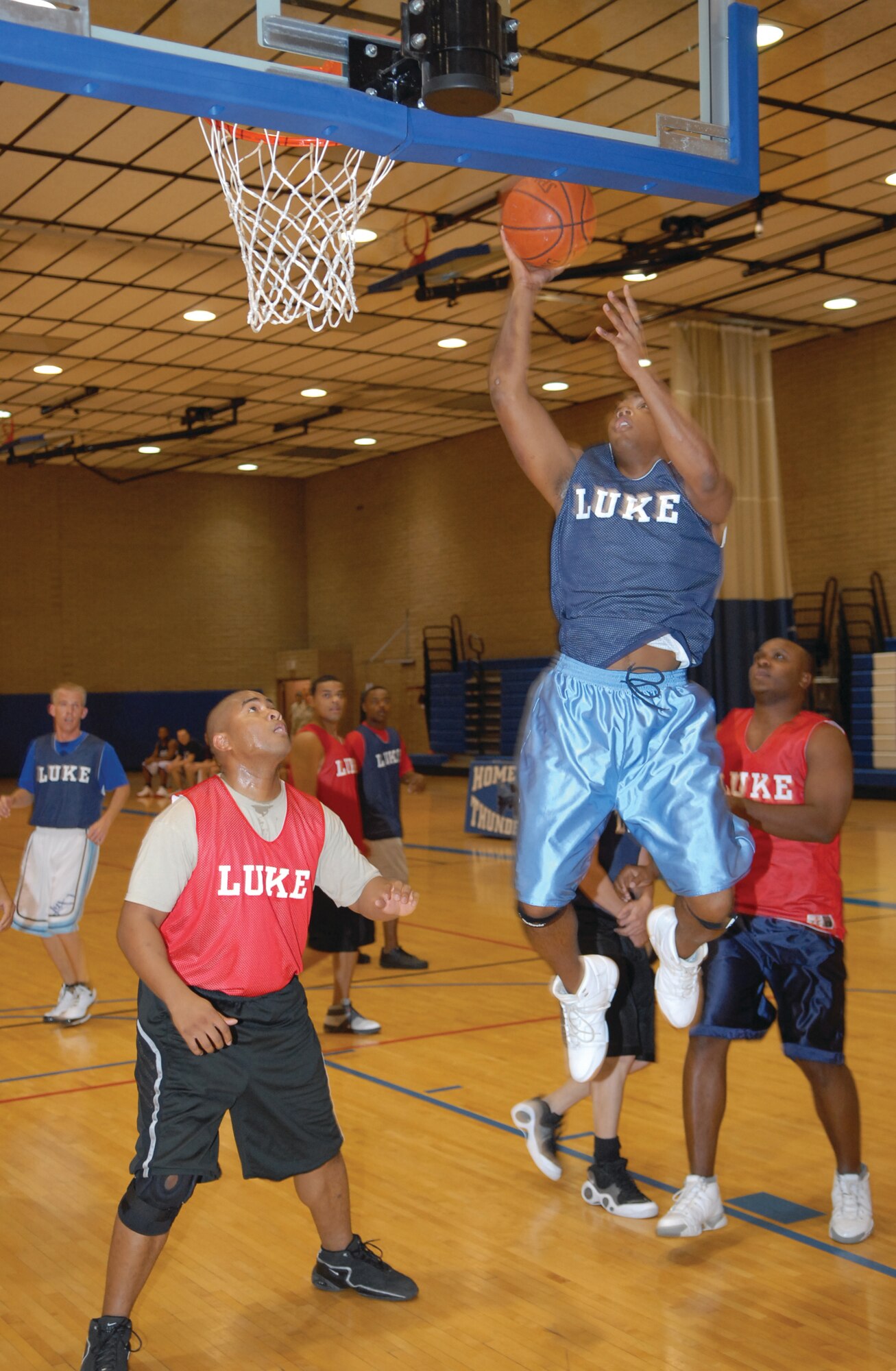 Jose Hoskins, 56th Security Forces Squadron power forward, soars over Timothy Robertson, 607th Air Control Squadron Dec. 3 duringan intramural basketball game at the fitness center. ACS won the game 49-45.