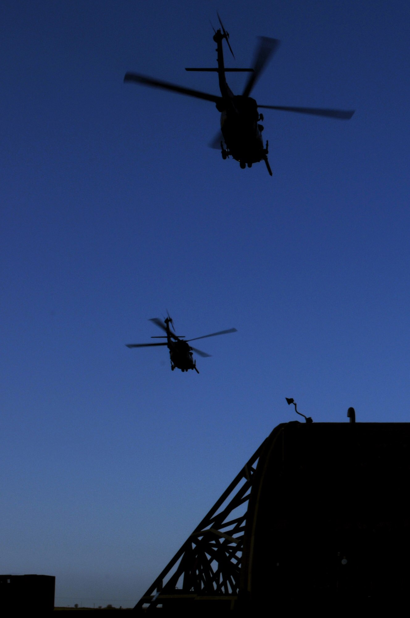 Two HH-60G Pave Hawks with the 56th Rescue Squadron take off to fly more than 500 miles west of Ireland for a real-world rescue mission Dec. 10 at Royal Air Force Lakenheath, England. A crew member of a cargo ship suffered a serious head injury requiring a medical evacuation, and U.S. forces were called upon to help. (U.S. Air Force photo/Staff Sgt. Nathan Gallahan) 
