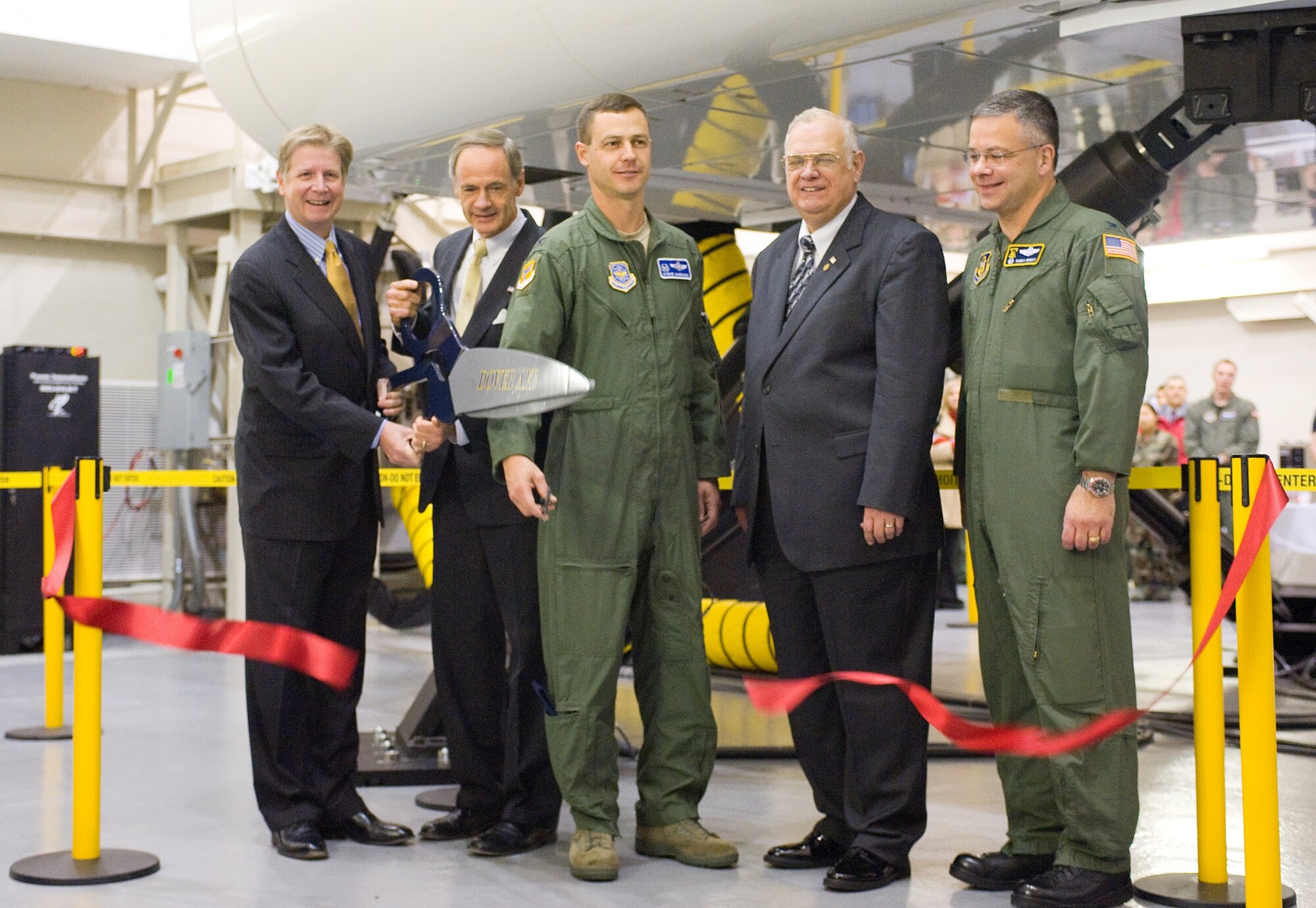 (From left) Mark McGraw, the vice president of Boeing Training and Systems Services; Senator Tom Carper; Col. Steven Harrison, 436th Airlift Wing commander; Carleton E. Carey, mayor of Dover; and Col. Randal Bright, 512th AW commander, cut the ribbon for the new C-17 Globemaster III simulator facility Dec. 5.  The $18 million simulator is cheaper to operate than a C-17, costing $500 an hour compared to the $18,000 an hour cost of flying the airlifter. (U.S. Air Force photo by Tom Randle)