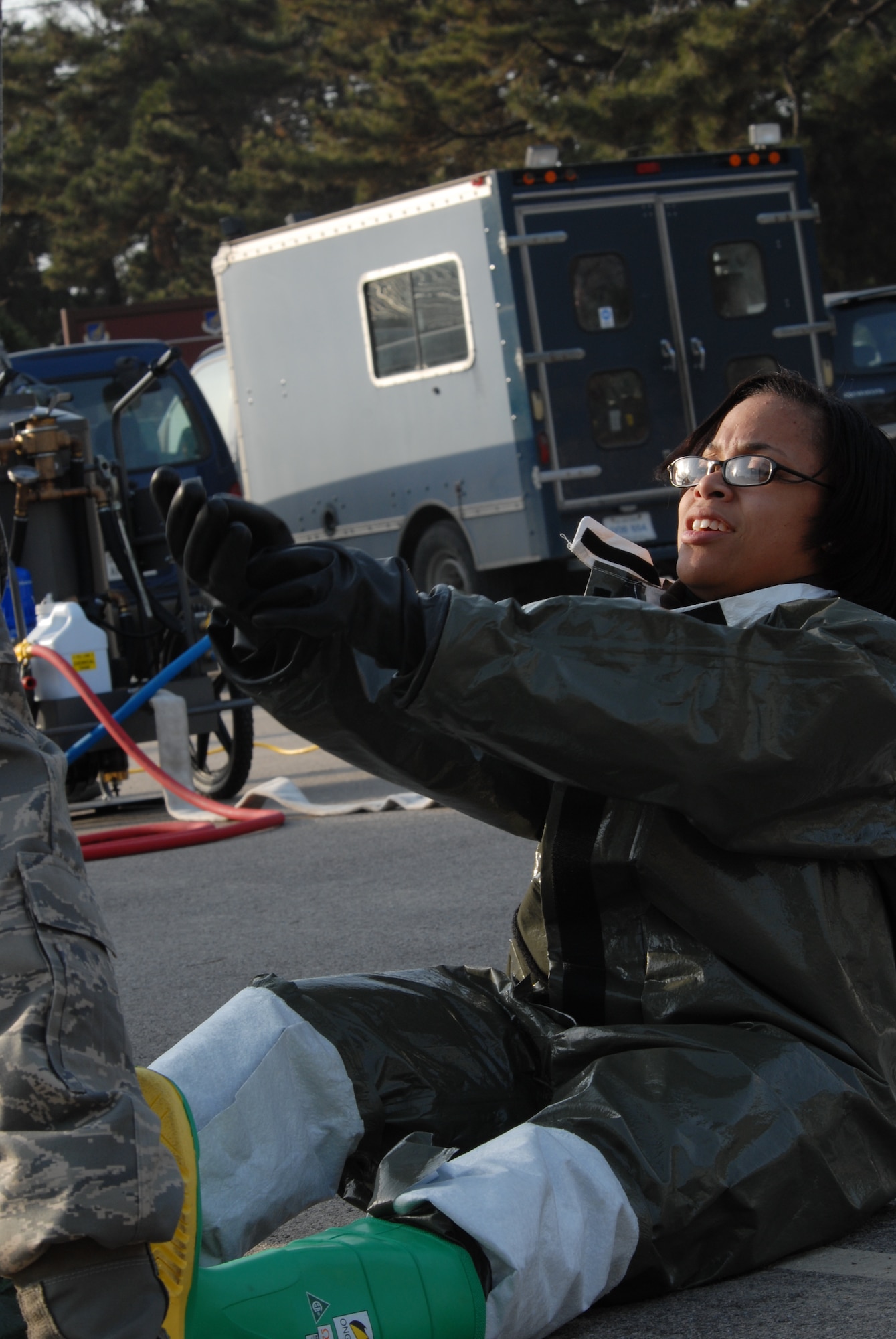 KUNSAN AIR BASE, Republic of Korea – Staff Sgt. Suzette Skrecz, 8th Medical Support Squadron, puts on a Disposable Toxicological Agent Protective System during a All Hazards  Response Training scenario at Kunsan Air Base, Republic of Korea, Dec. 9, 2008. AHRT is a weeklong training that tests the all the base agencies on their response and capabilities during crisis scenarios.(U.S. Air Force photo by: Senior Airman Angela Ruiz)
