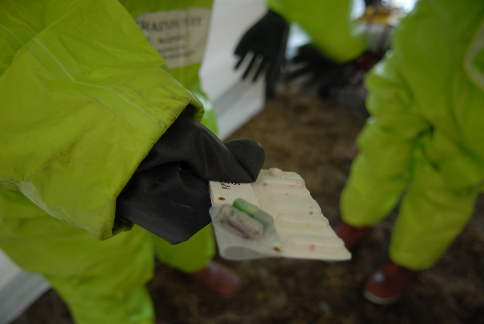 KUNSAN AIR BASE, Republic of Korea – Senior Airman Joseph Bonita, 8th Medical Operations Squadron, uses a protective strip to test the area for chemicals during a All Hazards Response Training scenario at Kunsan Air Base, Republic of Korea, Dec. 9, 2008. AHRT is a weeklong training that tested the all the base agencies on their response and capabilities during  crisis scenarios.(U.S. Air Force photo by: Senior Airman Angela Ruiz)