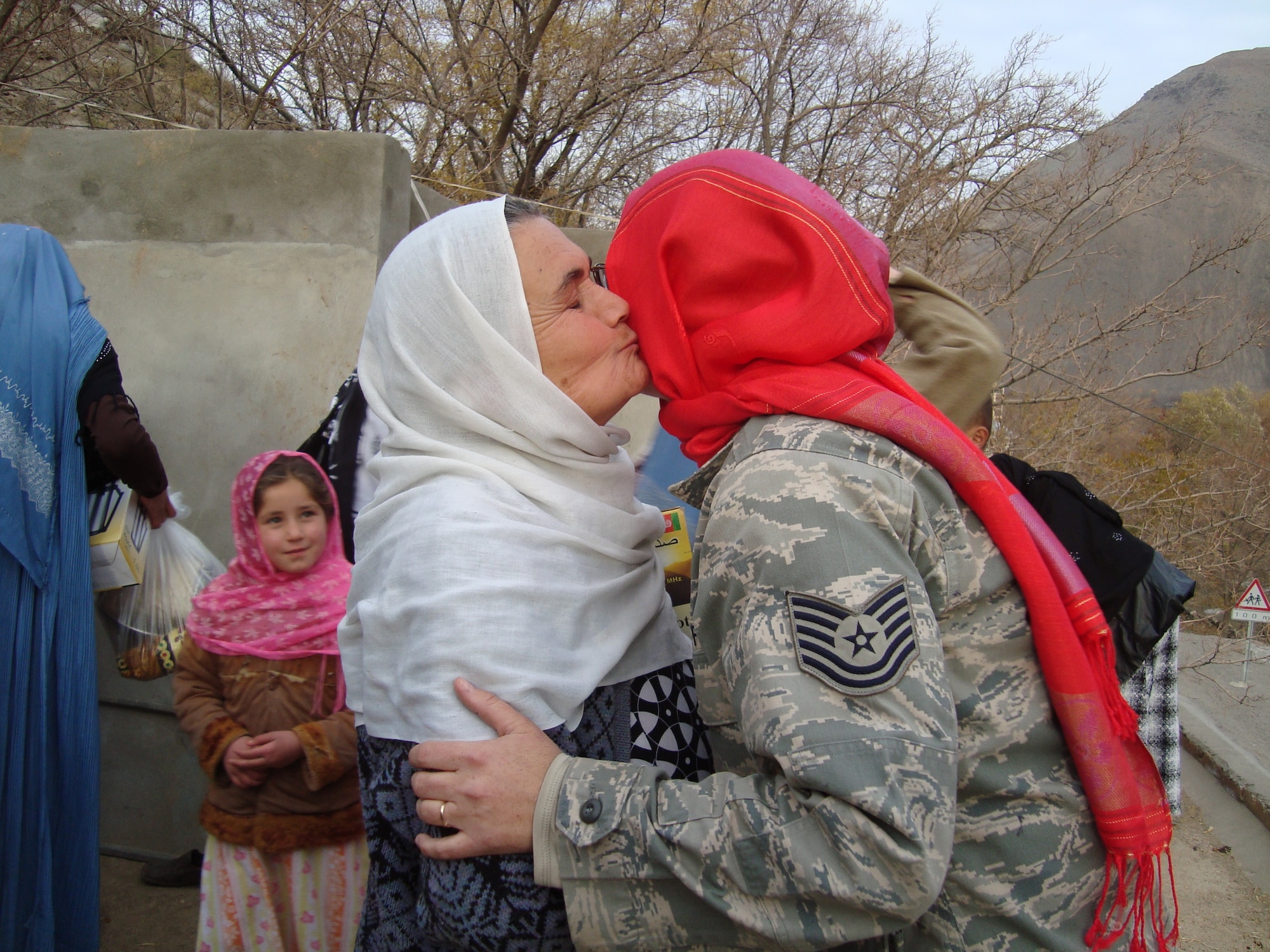 An Afghan woman greets Tech. Sgt. Dawn Allison-Hess of the Panjshir Provincial Reconstruction Team woman’s affairs team during the woman’s shura held on Dec. 2 in Bazarak District of Panjshir.

