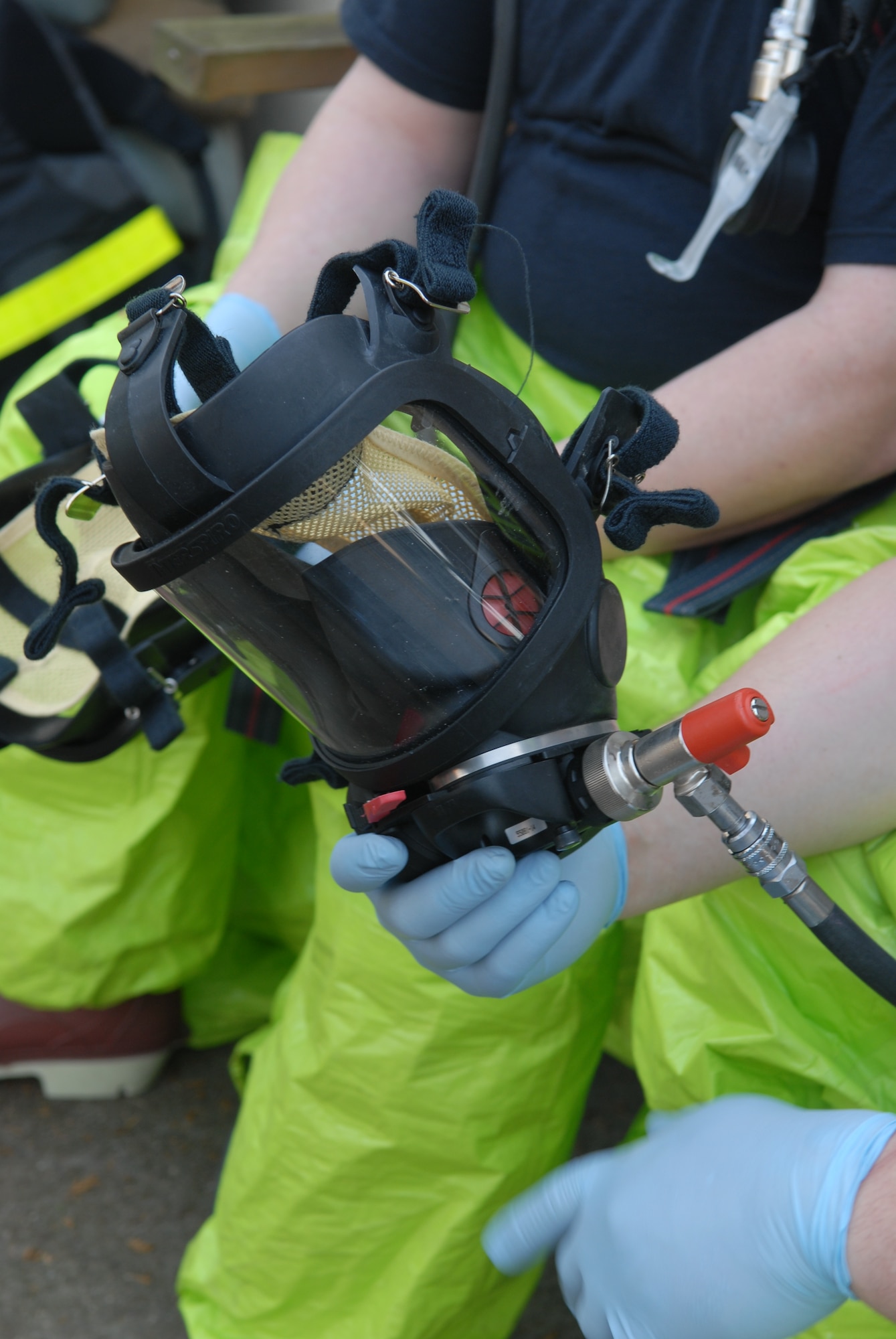 KUNSAN AIR BASE, Republic of Korea -- Senior Airman Brandon Kamai, 8th Medical Operations Squadron, inspects his Self Contained Breathing Apparatus mask during the All Hazards Response Training here Dec. 9. AHRT is a week-long training that tested all the base agencies on their response and capabilities during  crisis scenarios.(U.S. Air Force photo by: Senior Airman Angela Ruiz)