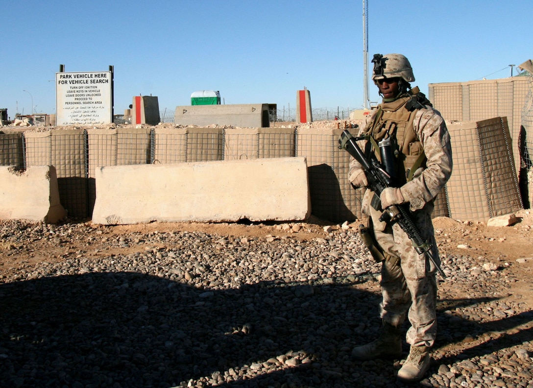 Second Lt. Derek Cash, a platoon commander with 2nd Battalion, 25th Marine Regiment, supervises his Marines as they search a vehicle at a base security checkpoint here Dec. 11, 2008.  Cash, now a first lieutenant, is currently the executive officer for Weapons Company, 2/25 in Garden City, N.Y.  Cash was commissioned through the Officer Candidate Class- Reserve program in 2008. In his civilian career he works at a large international banking firm in New York City.