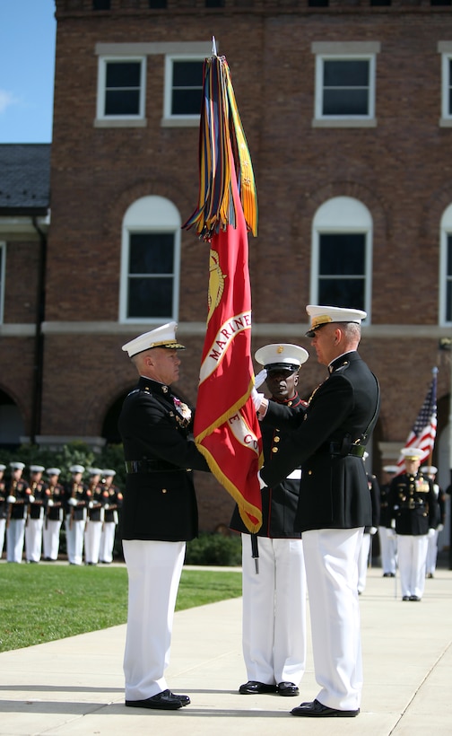 Gen. James Amos recieves the Marine Corps Colors from Gen. James T. Conway during a change-of-command ceremony at Marine Barracks Washington Oct. 22. Conway relinguished command of the Marine Corps to Amos, who became the 35th Commandant of the Marine Corps.