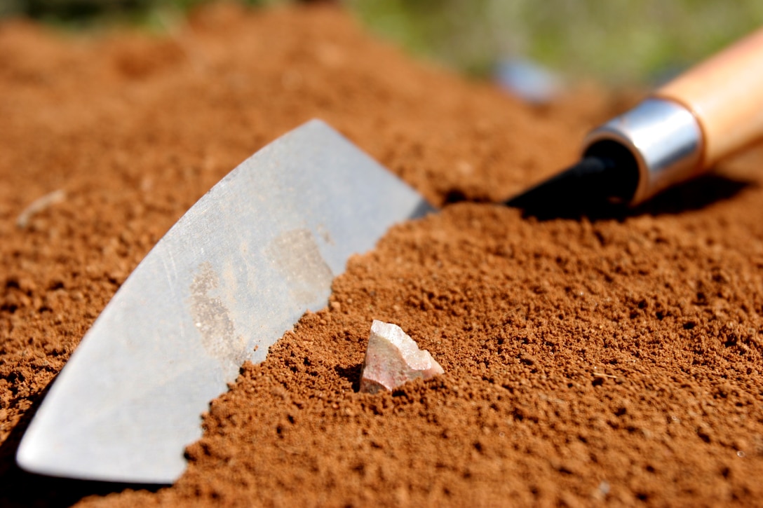 A rare mineral called Piedra De Lumbre lies besides an archeological tool after being excavated site at Camp Pendleton. Excavation sites on base are dated from 200 to more than 9,000 years old.