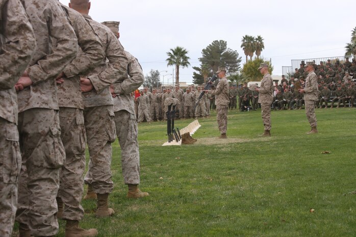Marines with 2nd Battalion, 7th Marine Regiment place the fourth memorial of 20 for service members that gave the ultimate sacrifice during 2/7’s recent deployment to Afghanistan at a memorial service Dec. 12 on the Combat Center’s Lance Cpl. Torrey L. Gray Field.  2/7 Marines stood in formation as service members, family and friends watched as each fallen man was given a proper memorial.