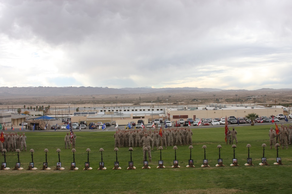 Marines and sailors with 2nd Battalion, 7th Marines stand in formation behind the 20 memorials of service members who gave the ultimate sacrifice during the unit’s recent deployment to Afghanistan at a memorial service Dec. 12 on the Combat Center’s Lance Cpl. Torrey L. Gray Field.