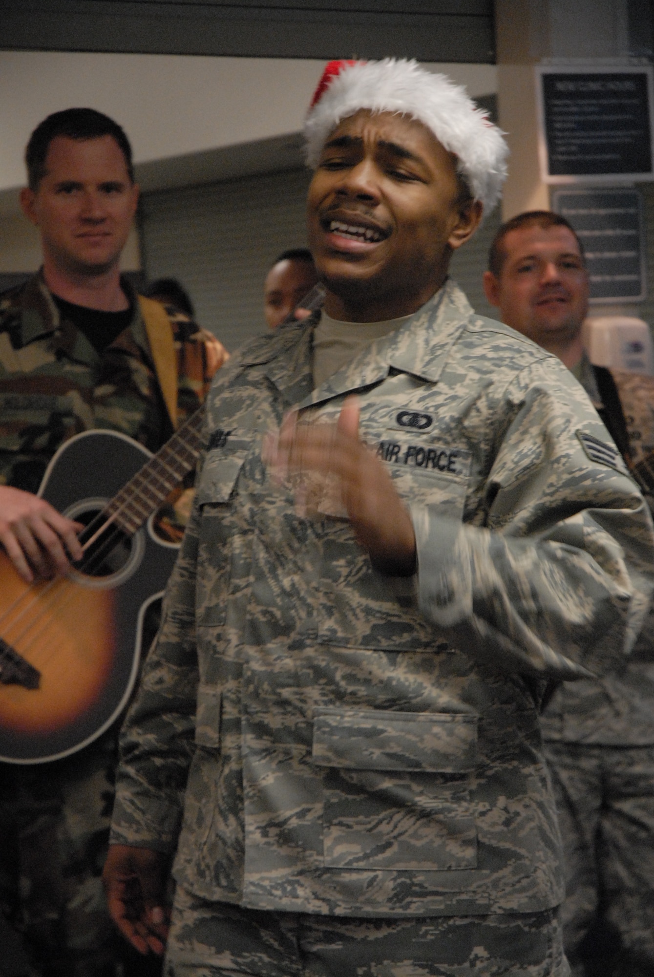 Senior Airman Andrew Jones sings for the members of the 8th Fighter Wing at Kunsan Air Base, Republic of Korea, Dec. 11, 2008. Pacific Trends sang Christmas carols for the 8th Fighter Wing, the Republic of Korea Air Forces, the employees at Gunsan City Hall and the members of the Korean National Police. (U.S. Air Force Photo by SSgt Jason Colbert)