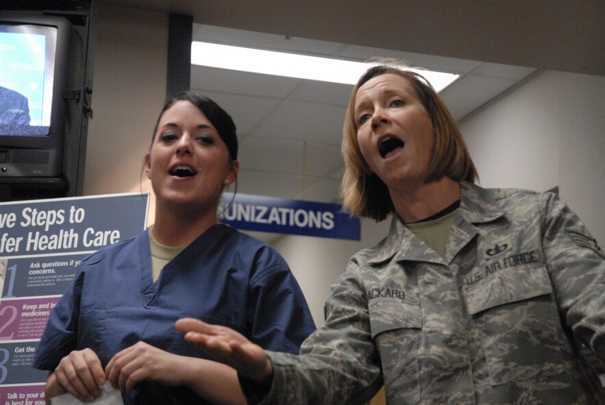 Senior Airman Jennifer Cook, 8th Medical Operations Squadron, and Staff Sgt. Rebecca Packard with the PACAF Band, Pacific Trends, sing Christmas carols at Kunsan Air Base, Republic of Korea, Dec. 11, 2008. Pacific Trends sang Christmas carols for the 8th Fighter Wing, the Republic of Korea Air Forces, the employees at Gunsan City Hall and the members of the Korean National Police. (U.S. Air Force Photo by SSgt Jason Colbert)