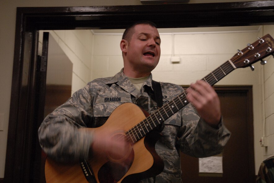 Staff Sgt. Daniel Bragdon, guitarist with the PACAF band Pacific Trends, sings "Let It Snow" for the memebers of the 8th Communications Squadron and Public Affairs, at Kunsan Air Base, Republic of Korea, Dec. 11, 2008. Pacific Trends sang Christmas carols for the 8th Fighter Wing, the Republic of Korea Air Forces, the employees at Gunsan City Hall and the members of the Korean National Police. (U.S. Air Force Photo by SSgt Jason Colbert)