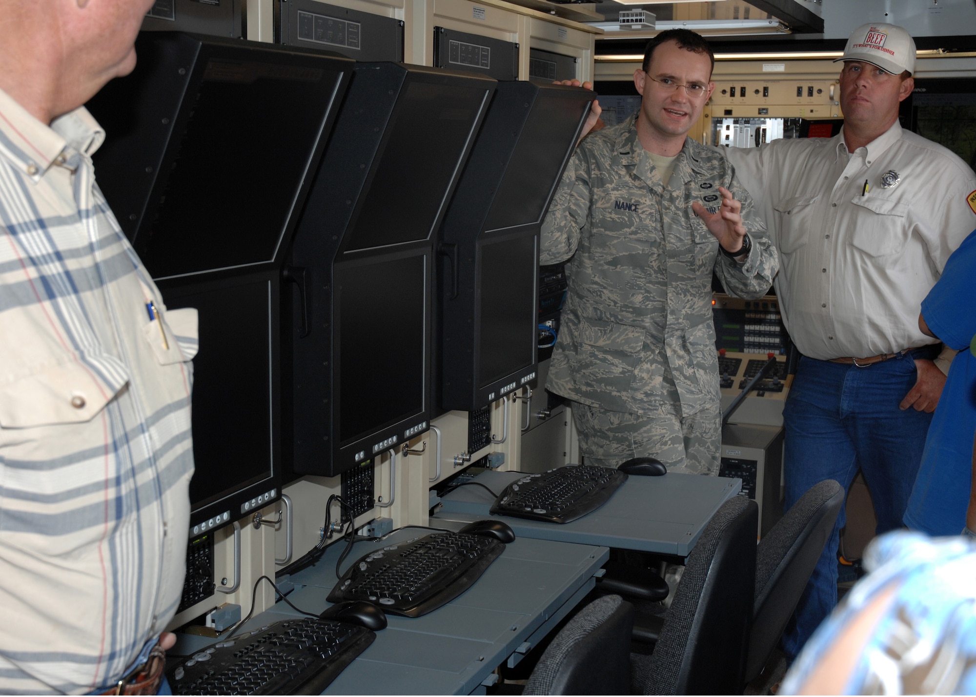 CANNON AIR FORCE BASE, N.M. - First Lt. Charles Nance, 3rd Special Operation Squadron Assistant Chief of Current Operations, explains to an audience of contractors the technology in the 3rd SOS's Dragon Operations Center July 10, 2008, at a barbeque the squadron held for contractors who helped build the facility.  The operations building project provided a first-class, flexible facility that can accommodate all personnel.  The effective management of this project by 3rd SOS personnel helped the squadron win the covetous 2008 Air Force Special Operations Command Meritorious Unit Award for the period of Oct. 1, 2007 to Sept. 30, 2008. (U.S. Air Force photo/Airman 1st Class Danielle Martin)