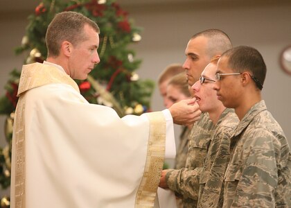 12/8/2008 - Basic trainees receive communion from Chaplain (Lt. Col.) Michael Butler during mass Monday. Chaplain Butler was recently bestowed the honor of monsignor in the Roman Catholic Church. (USAF photo by Robbin Cresswell)