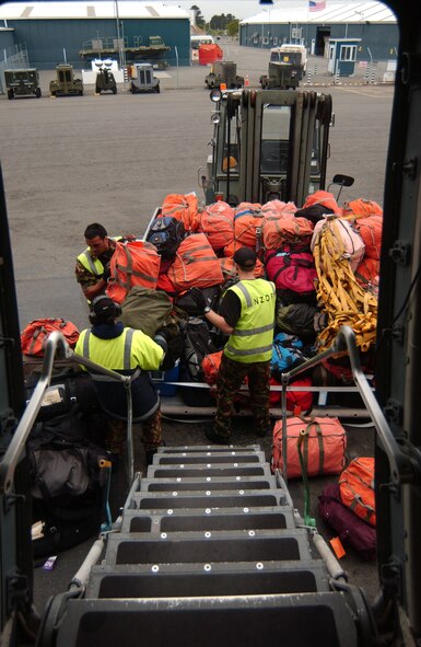 Members of the New Zealand Defence Force prepare to load baggage on a C-17 Globemaster III prior to an Operation Deep Freeze mission to Antarctica Dec. 1. (U.S. Air Force photo/Staff Sgt. Eric Burks) 