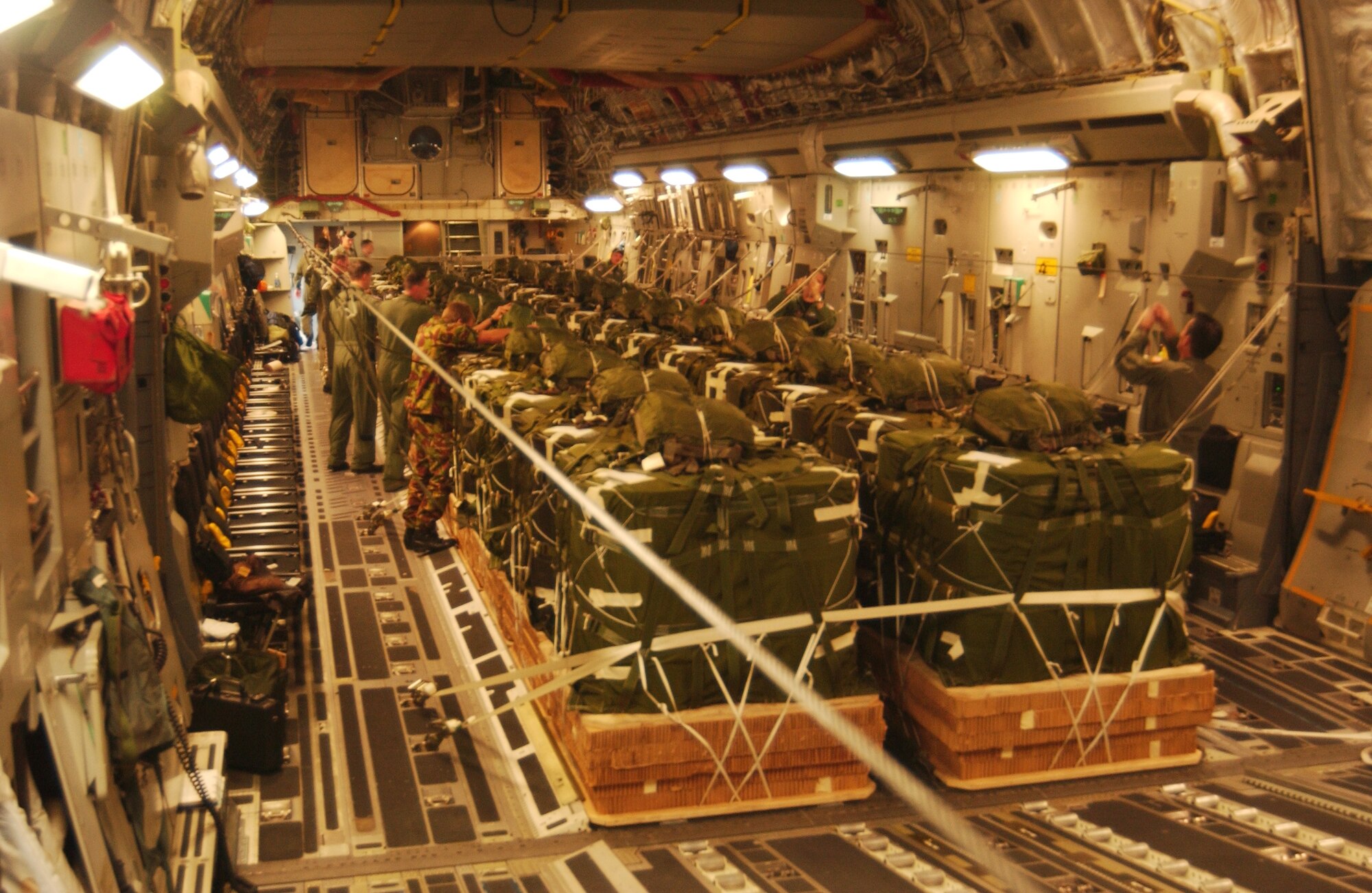 Team McChord Airmen and members of the New Zealand Defence Force secure supplies and inspect a load prior to an airdrop mission to the Antarctic Gamburtsev Mountain Province Dec. 1. (U.S. Air Force photo/Staff Sgt. Eric Burks) 