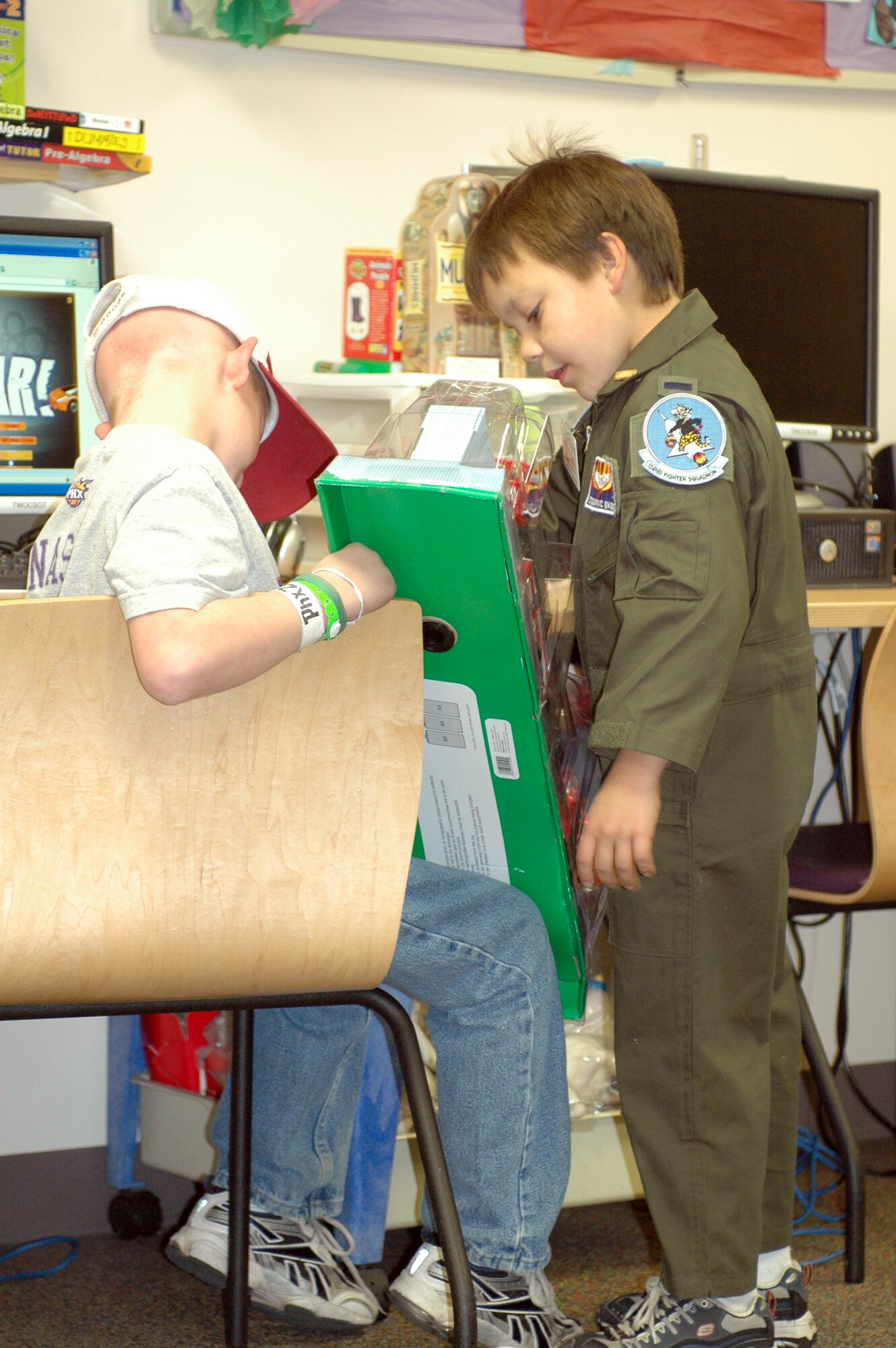 PHOENIX – Honorary 162nd Fighter Wing member Dominic Magne, 7, gives a fellow patient a toy fire truck from the wing’s collection of donations to Phoenix Children’s Hospital Dec. 11. The Tucson-based Guard unit held a gift drive in November and December resulting in more than 250 toys, games, books and DVDs. Every child received a gift with extras donated to the hospital for future patients. (Air National Guard photo by Capt. Gabe Johnson)