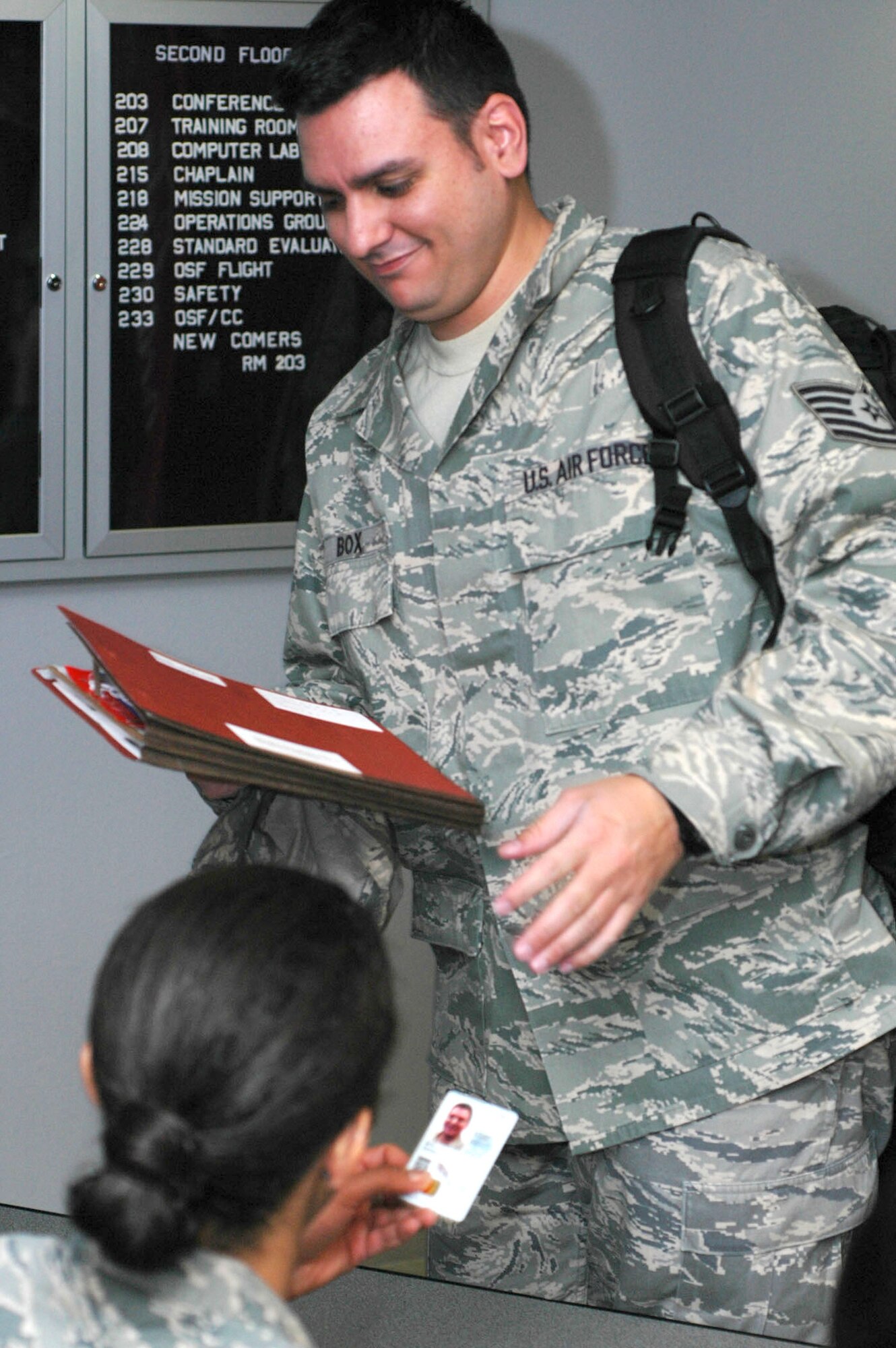 Tech. Sgt. Daniel Box, 302nd Aeromedical Staging Squadron, has his records reviewed by Airman Kelly Duncan Dec. 12 while processing through a deployment line at Peterson Air Force Base, Colo. Sergeant Box and more than 35 other members of the Air Force Reserve's 302nd Airlift Wing departed Colorado for Puerto Rico's Muniz Air National Guard Base, where they will support U.S. Southern Command with logistics and contingency efforts through Operation Coronet Oak. The operation encompasses several missions, including resupply of U.S. embassies, medical evacuation missions and support for U.S. troops in the region. Airman Duncan is a customer service technician with the 302nd Mission Support Squadron. (U.S. Air Force photo/Senior Airman Stephen J. Collier)