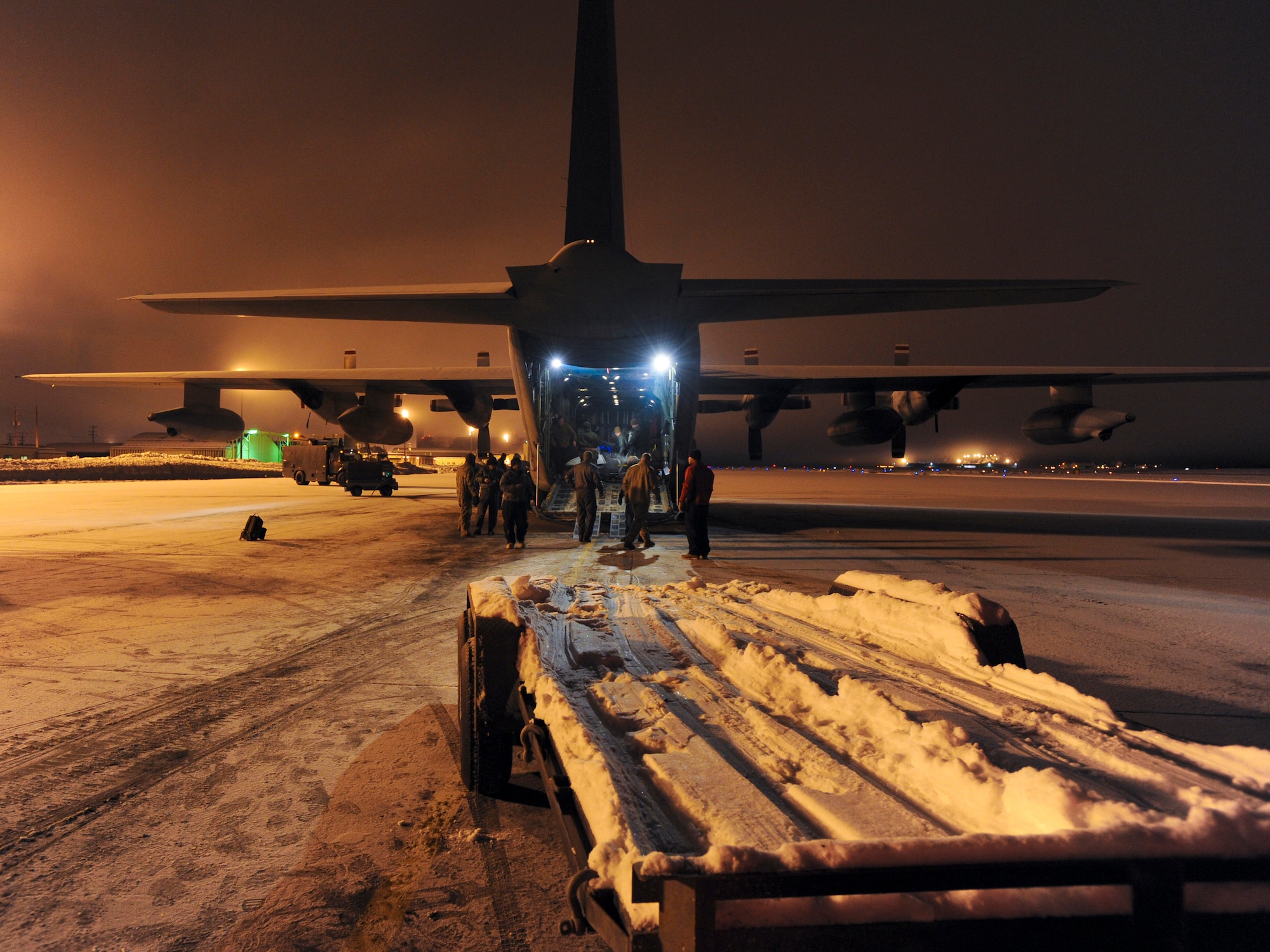 ELMENDORF AIR FORCE BASE, Alaska -- A trailers sits empty after U.S. Marines with Company D, Anti-Terrorism Battalion 4th Marine Division, loaded snowmachines into a Marine C-130 Hercules. The Marines will use the snowmachines to deliver toys to children living in remote locations around Alaska. With multiple villages that will be visited, three different flights will take personnel to their starting locations. (U.S. Air Force photo by/Staff Sgt. Joshua Garcia)