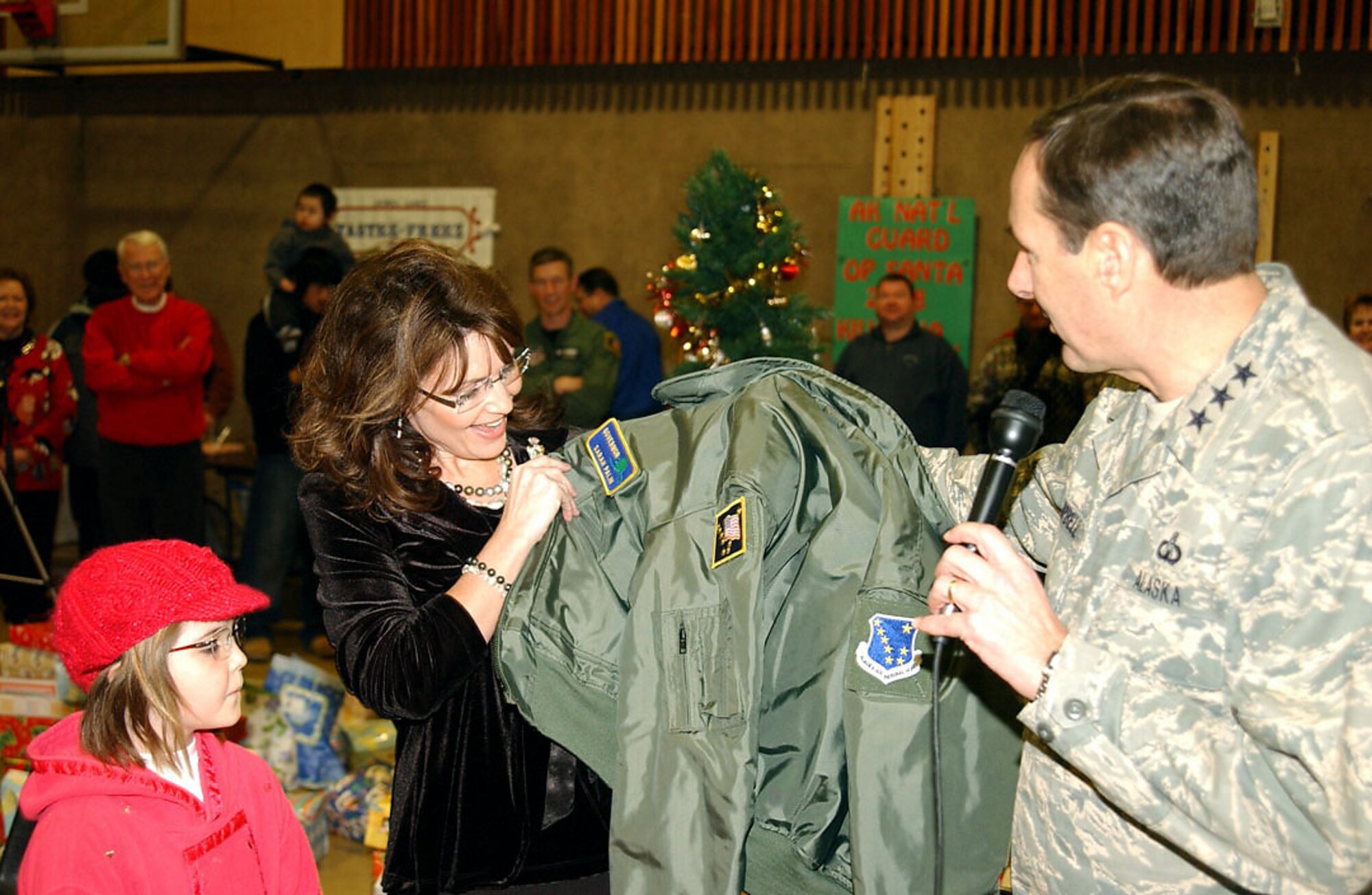 Alaska Gov. Sarah Palin receives a flight jacket from Lt. Gen. Craig E. Campbell as a token of thanks for supporting the Alaska National Guard during Operation Santa Claus 2008 on Dec. 6 in Kivalina, Alaska. Operation Santa Claus, an Alaska National Guard community relations and support program, provides toys, books and school supplies for young people in communities across the state. General Campbell is Alaska's adjutant general. (U.S. Army photo/Spc. Paizley Ramsey)