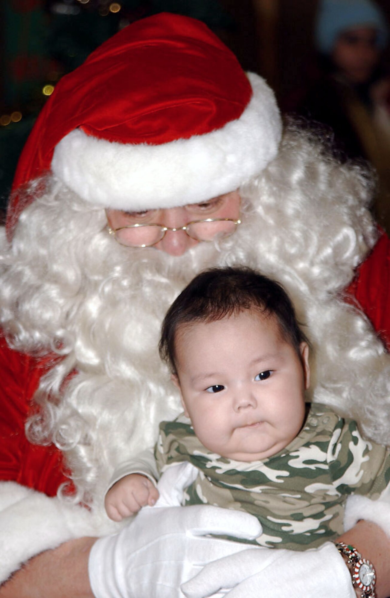 Santa Claus holds one of the children of Kivalina while passing out gifts during Operation Santa Claus Dec. 6 in Kivalina, Alaska. Operation Santa Claus, an Alaska National Guard community relations and support program, provides toys, books and school supplies for young people in communities across the state. (U.S. Army photo/Spc. Paizley Ramsey)
