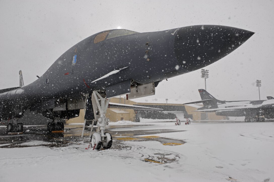 A B-1B Lancer is parked on the flight line here, Dec. 11. De-icing the aircraft is necessary during winter weather to maintain operational readiness. (U.S. Air Force photo by Airman First Class Corey Hook)