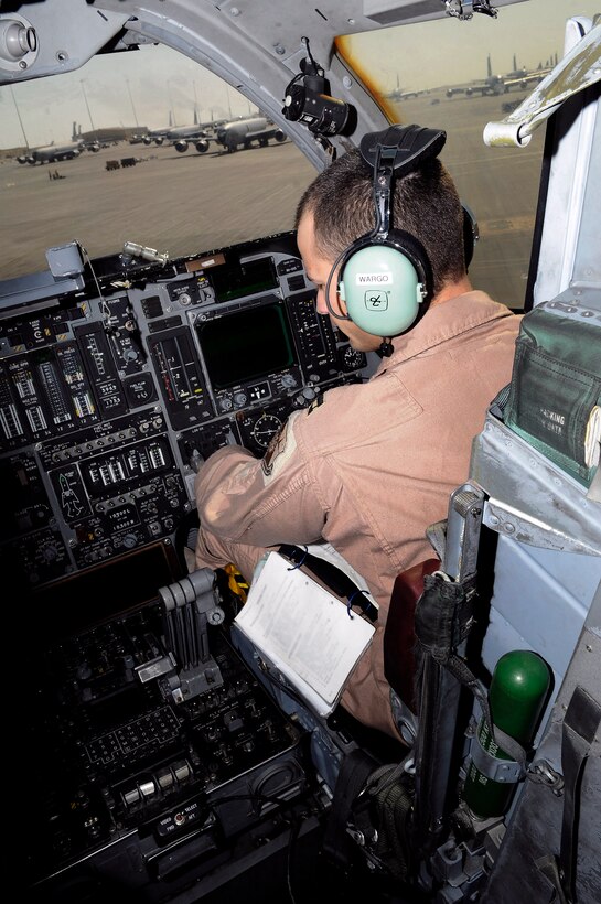 Capt. Aaron Wargo works his way through preflight checklists from the co-pilot seat in the cockpit of a B-1B Lancer Dec. 9 at an air base in Southwest Asia. A preflight crew prepares the aircraft for flight in order to allow the crew actually flying to maximize their available flight time. Captain Wargo hails from Garden Grove, Calif., and is deployed from Ellsworth Air Force Base, S.D. He is a pilot assigned to the 379th Expeditionary Bomb Squadron. (U.S. Air Force photo illustration/Tech. Sgt. Michael Boquette) 
