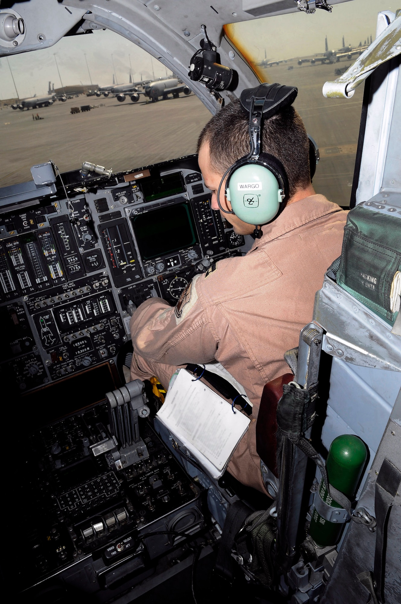 Capt. Aaron Wargo works his way through preflight checklists from the co-pilot seat in the cockpit of a B-1B Lancer Dec. 9 at an air base in Southwest Asia. A preflight crew prepares the aircraft for flight in order to allow the crew actually flying to maximize their available flight time. Captain Wargo hails from Garden Grove, Calif., and is deployed from Ellsworth Air Force Base, S.D. He is a pilot assigned to the 379th Expeditionary Bomb Squadron. (U.S. Air Force photo illustration/Tech. Sgt. Michael Boquette) 
