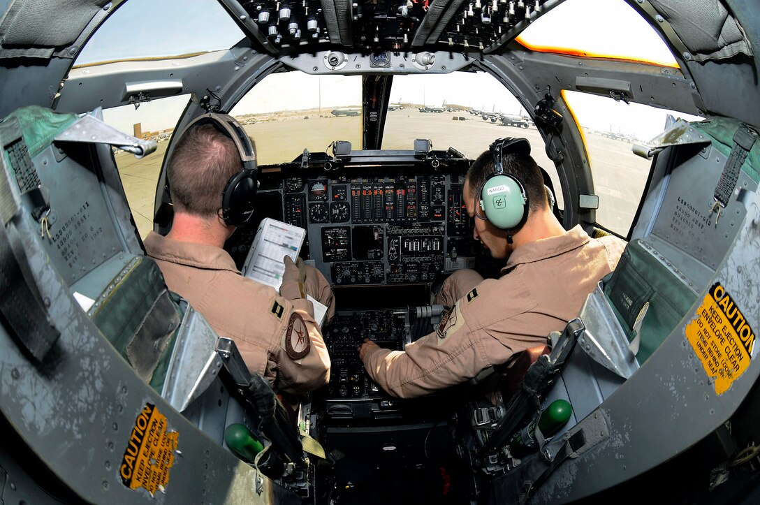 Capt. Chad Hillen and Capt. Aaron Wargo work their way through preflight checklists from the cockpit of a B-1B Lancer Dec. 9 at an air base in Southwest Asia. Captain Hillen is a B-1B pilot and native of Sewell, N.J. Captain Wargo hails from Garden Grove, Calif. They are both pilots assigned to the 379th Expeditionary Bomb Squadron deployed from Ellsworth Air Force Base, S.D. (U.S. Air Force photo illustration/Tech. Sgt. Michael Boquette) 
