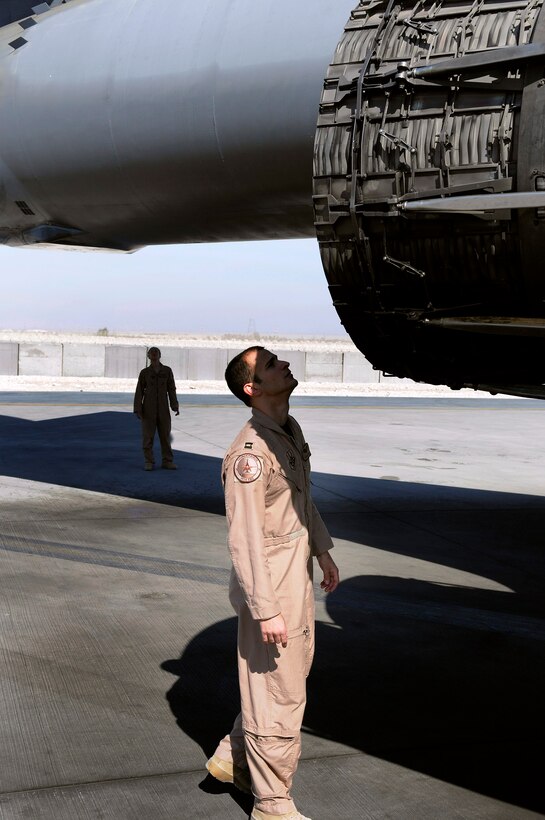 Capt. Aaron Wargo checks out a B-1B Lancer engine while Capt. Daniela Lozano looks over the tail section during a preflight walk around of the aircraft Dec. 9 at an air base in Southwest Asia. Captain Wargo is a B-1B pilot and a native of Garden Grove, Calif. Captain Lozano is a weapons system officer and hails from Dallas. Both are assigned to the 34th Expeditionary Bomb Squadron and deployed from Ellsworth Air Force Base, S.D. (U.S. Air Force photo/Tech. Sgt. Michael Boquette) 
