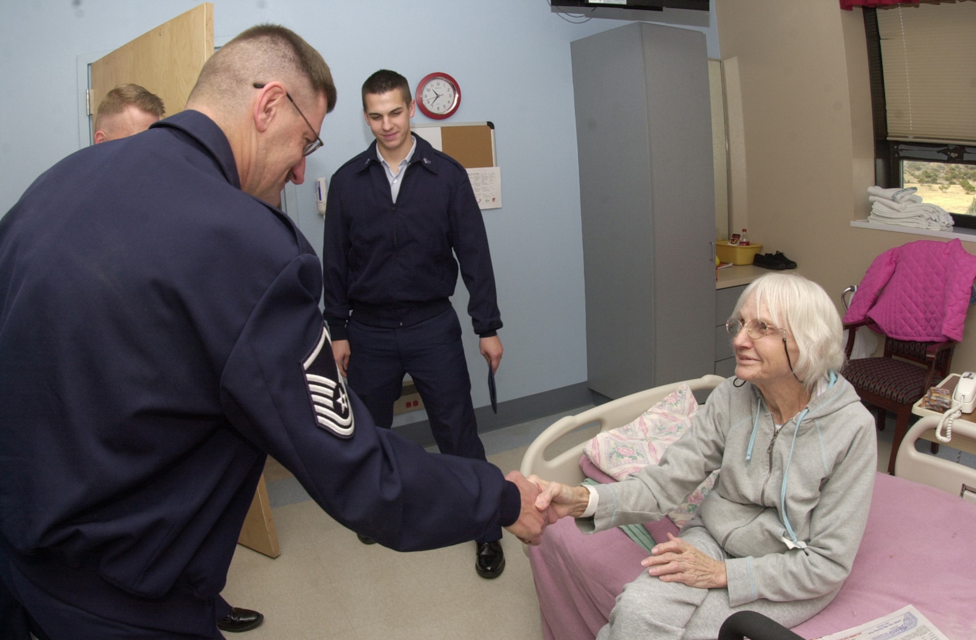 Master Sgt. John Teutsch, 17th Medical Group, thanks 84-year-old Ruby Lewis, a patient at the Veterans Administration Medical Center. Ms. Lewis served in the Army as a switchboard operator at Goodfellow Field, Texas - which is now Goodfellow Air Force Base. (U.S. Air Force photo by Senior Airman Luis Loza Gutierrez)