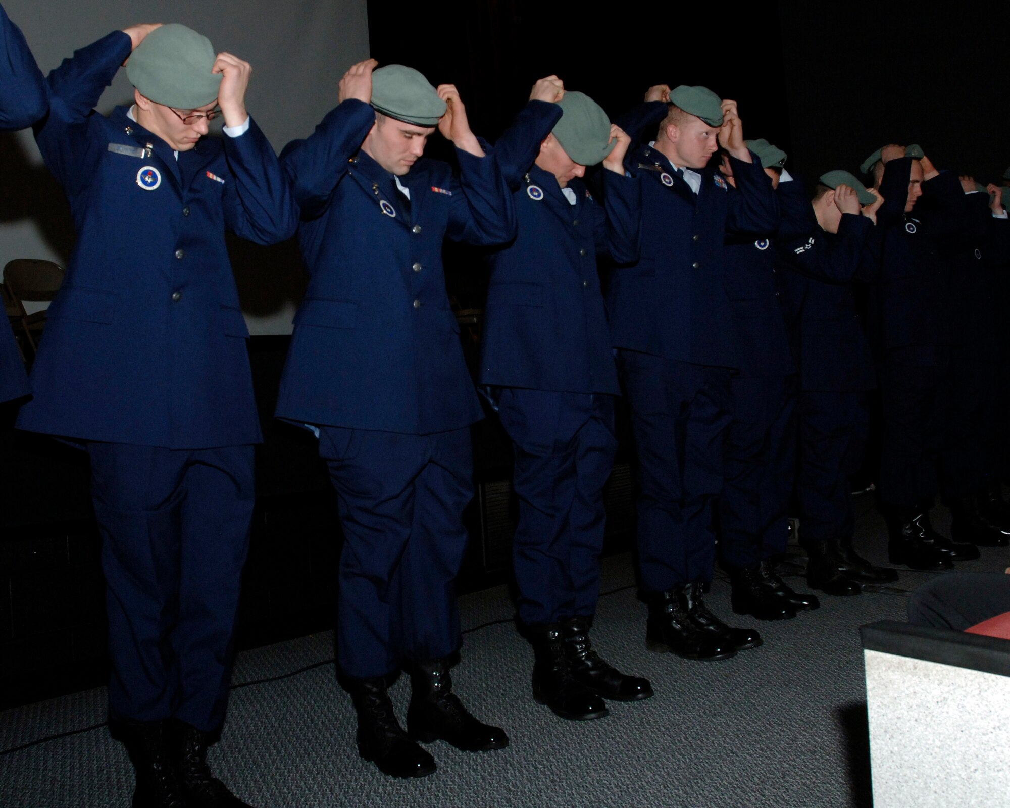 FAIRCHILD AIR FORCE BASE, Wash. – Graduates of the 66th Training Squadron Survival, Evasion, Resistance and Escape Class 09-01 don their berets during a SERE graduation at the base theater Dec. 10. The beret is selectively bestowed to SERE specialists to reflect their professionalism, excellence and dedication. (U.S. Air Force photo / Airman 1st Class Melissa L. Barnett)