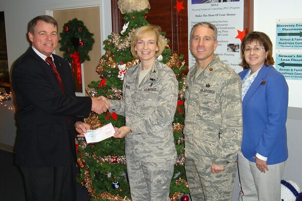 FAIRCHILD AIR FORCE BASE, Wash. – TriWest Healthcare Alliance Service Area Director Mike Hanley presents a check for $5,000 to the 92nd Medical Group Commander, Col. Anne Sproul, accompanied by Maj. Jason Knight, the 92nd Force Support Squadron commander, and Maureen Hartford, the acting Director of the Airman & Family Readiness Center, at Fairchild Dec. 11. TriWest donated the funds in the spirit of the holiday season. (U.S. Air Force photo / Master Sgt. Scott Woller)
