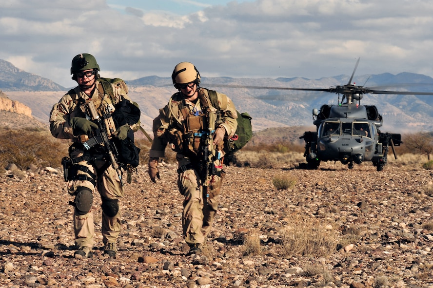 Two Air Force pararescuemen depart from a HH-60G Pave Hawk to aid casualties during a personnel recovery training exercise Dec. 7 at Davis-Monthan Air Force Base, Ariz.. More than 800 ground recovery personnel took part in Angel Thunder 2008, a combat search and rescue exercise. (U.S. Air Force photo/Senior Airman Noah R. Johnson) 