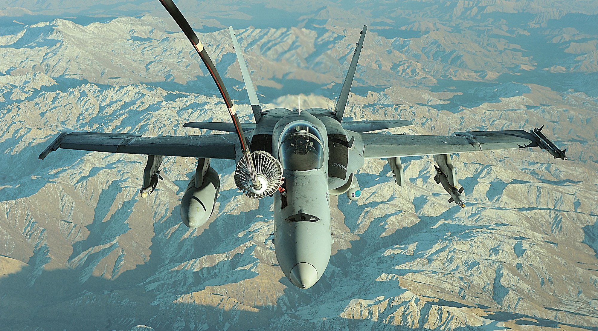 A KC-10 Extender from the 908th Expeditionary Aerial Refueling Squadron refuels a Navy F/A-18 Super Hornet Dec. 11 over Afghanistan. The KC-10 holds six tanks that carry more than 356,000 pounds of fuel. (U.S. Air Force photo/Staff Sgt. Aaron Allmon) 
