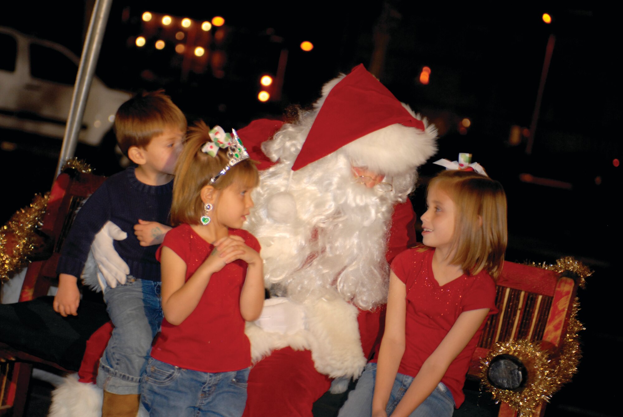 Lillian, Ella and Ben Morrow visit with Santa Claus and tell him what they want for Christmas at Holiday Magic, held Dec. 5 in the Desert Star Club parking lot. The event included real snow, the official Luke Christmas tree lighting, hay rides, vendors, as well as the chance to get a voucher for a free, live Christmas tree.