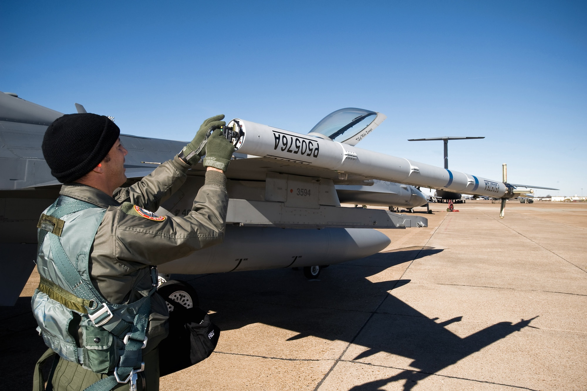 Lt. Col. Mitch Neff loads a data recording device into the air combat maneuvering instrumentation pod on an F-16 Fighting Falcon Dec. 4 at Green Flag East at Barksdale Air Force Base, La. The ACMI pods are being used on the F-16s to provide real-time 3-D flight data to the battlefield commander. Colonel Neff is a Colorado Air National Guard pilot with the 120th Fighter Squadron from Buckley AFB, Colo. (U.S. Air Force photo/Master Sgt. John Nimmo Sr.) 
