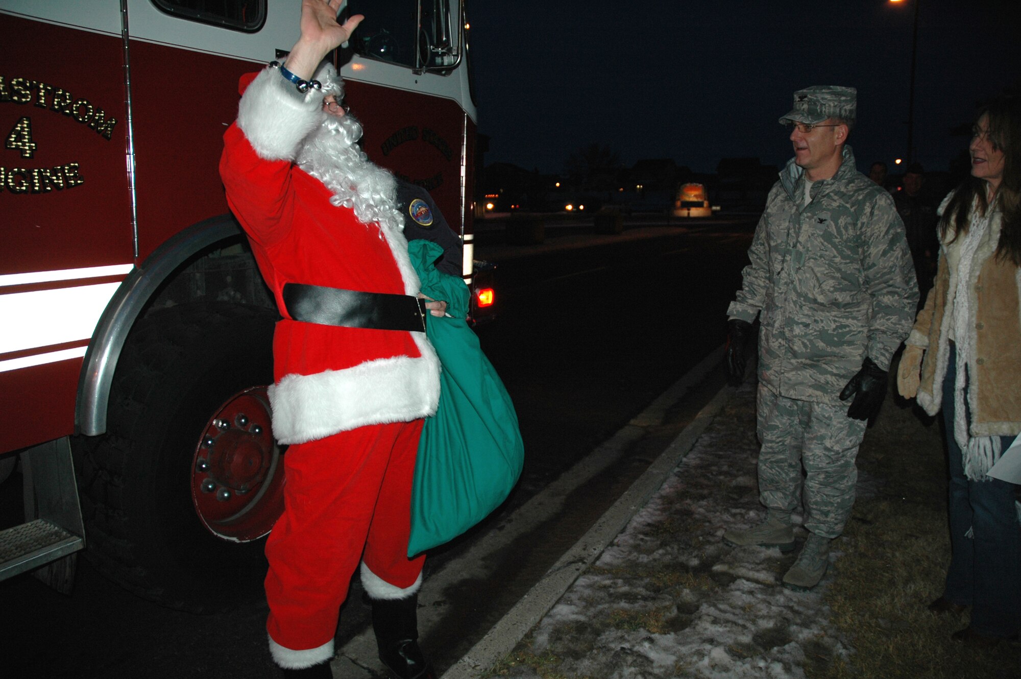 Col. Michael Fortney, 341st Missile Wing commander, and his wife, Karen, greet 'Santa Clause' outside of the Grizzly Bend Club Dec. 5, before the base Christmas tree lighting. (U.S. Air Force photo/Senior Airman Emerald Ralston)