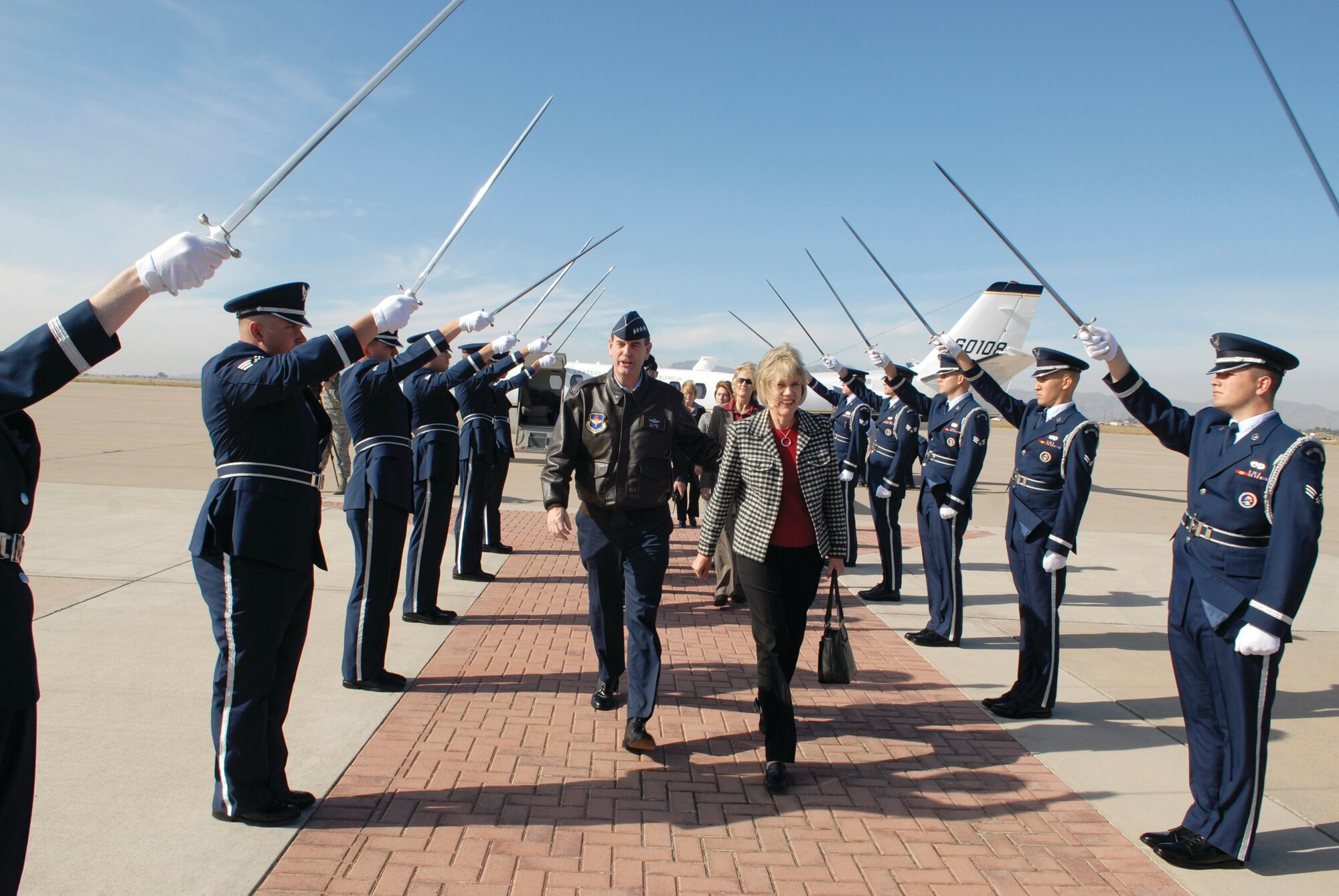 General Stephen Lorenz, AETC commander, and wife Leslie, walk through a 56th Fighter Wing Honor Guard cordon after arriving at Luke Air Force Base Monday. The four star general visited Luke Dec. 8 and 9.