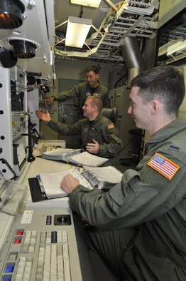 1st Lt. Mario Kuhn, 341st Operations Support Squadron deputy instructor, instructs 1st Lt. Donald Heaton, 12 Missile Squadron ICBM combat crew commander (left), and 1st Lt. Matthew Pecoraro, 341st OSS deputy instructor (right), in the Missile Procedures Trainer. They have just finished responding to an event and are discussing the principles involved. (U.S. Air Force photo/John Turner)
