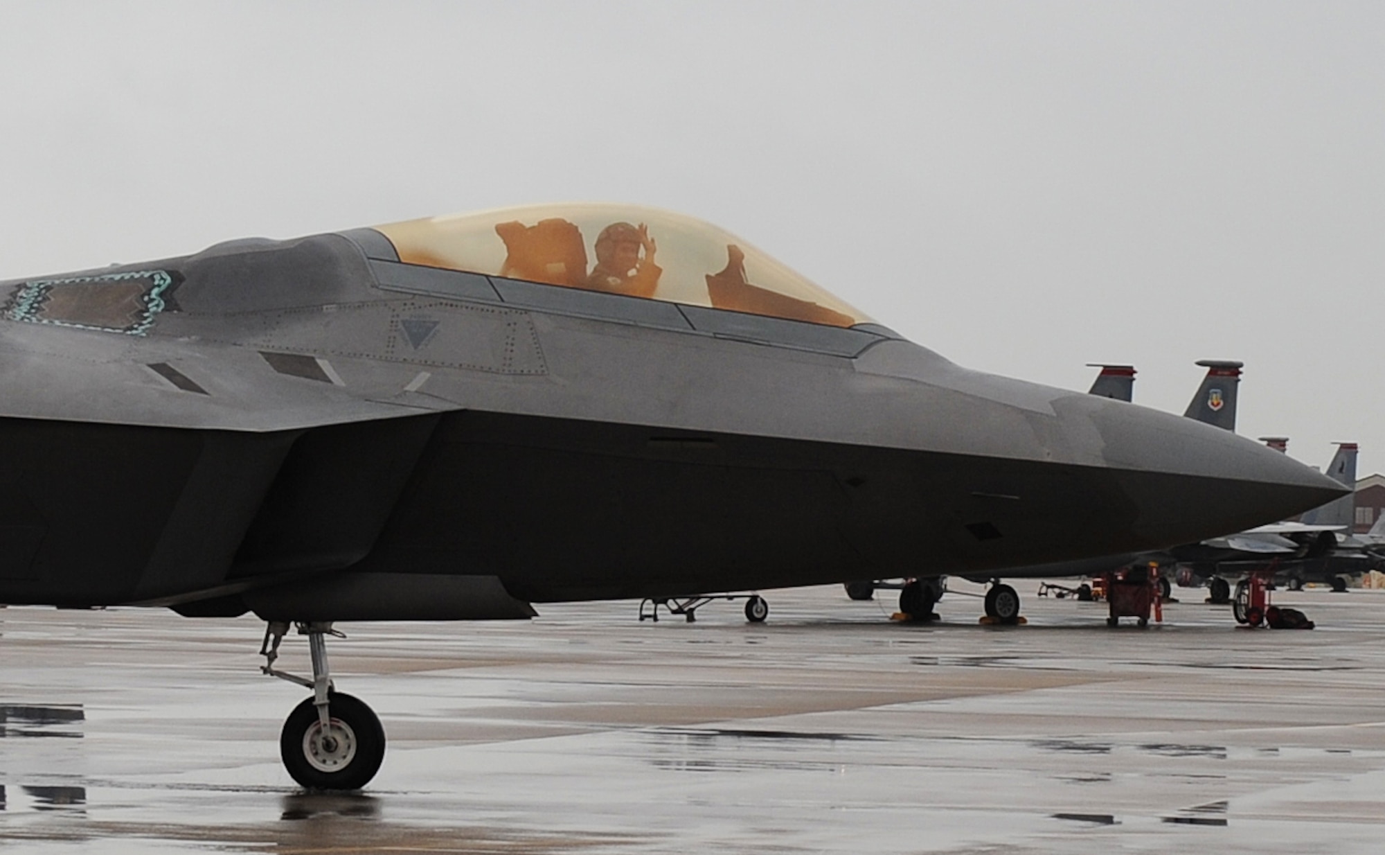 LANGLEY AIR FORCE BASE, Va. – Lt. Col. Kevin Fesler, 94th Fighter Squadron commander, waves to his friends and family as he taxis down the flight line Dec. 11.  This flight was Colonel Fesler’s last flight on active duty before transitioning to the Air Force Reserve.  (U.S. Air Force photo/Airman 1st Class Zachary Wolf)