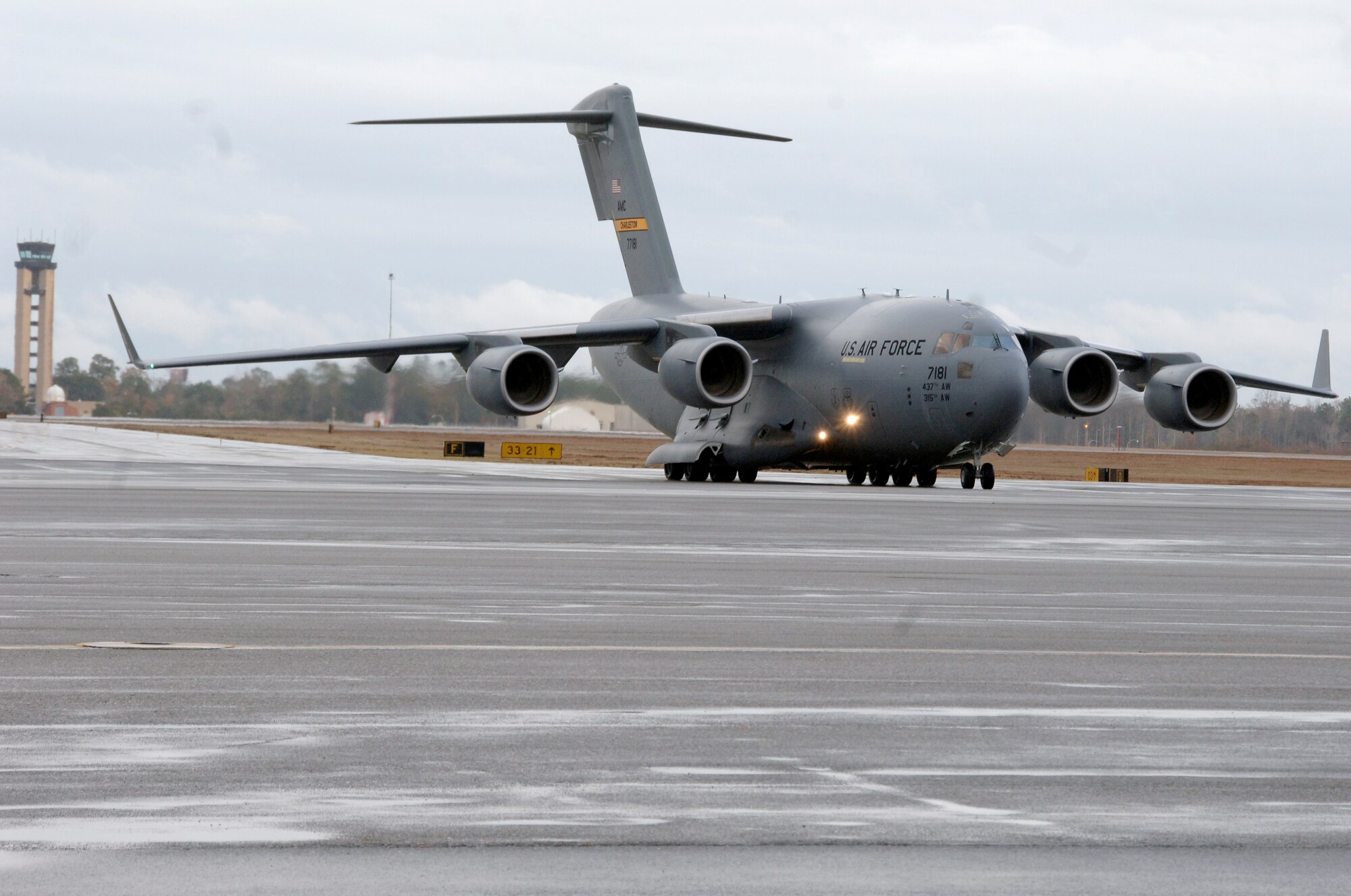 Brig. Gen. Janet Therianos helps steer in Charleston's newest C-17 on the flightline Dec 11. The P-181 C-17 is the second of ten new aircraft Charleston Air Force base is slated to receive within the next year. General Therianos is the director of Intelligence for Air Mobility Command. (U.S. Air Force photo/Staff Sgt. Marie Cassetty)