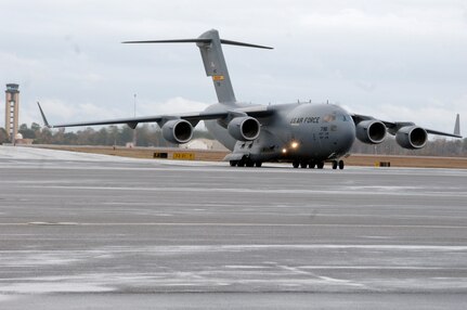 Brig. Gen. Janet Therianos helps steer in Charleston's newest C-17 on the flightline Dec 11. The P-181 C-17 is the second of ten new aircraft Charleston Air Force base is slated to receive within the next year. General Therianos is the director of Intelligence for Air Mobility Command. (U.S. Air Force photo/Staff Sgt. Marie Cassetty)