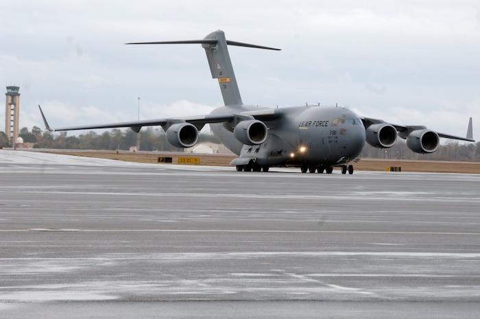 Brig. Gen. Janet Therianos helps steer in Charleston's newest C-17 on the flightline Dec 11. The P-181 C-17 is the second of ten new aircraft Charleston Air Force base is slated to receive within the next year. General Therianos is the director of Intelligence for Air Mobility Command. (U.S. Air Force photo/Staff Sgt. Marie Cassetty)