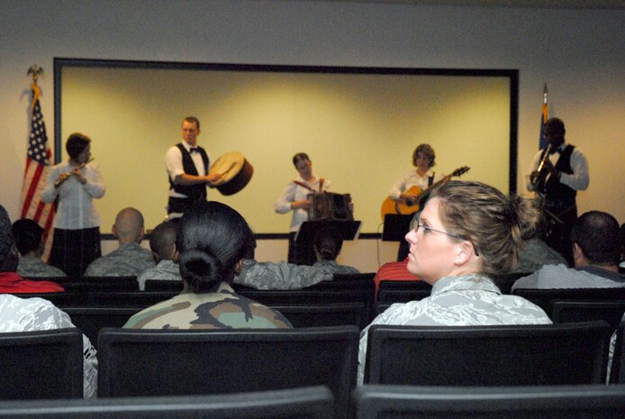 Airmen of the 437th Logistics Readiness Squadron watch a holiday caroling performance of the Heritage Aire Celtic Ensemble, Langley AFB, VA. at the squadron?s auditorium Dec. 10. The Air Combat Command band performed for Airmen, family members, civilian employees and retirees around the base blending traditional music of Ireland, Scotland and England with a contemporary musical style by creating a stunning musical tapestry. (U.S. Air Force photo/Tech. Sgt. David Watson)