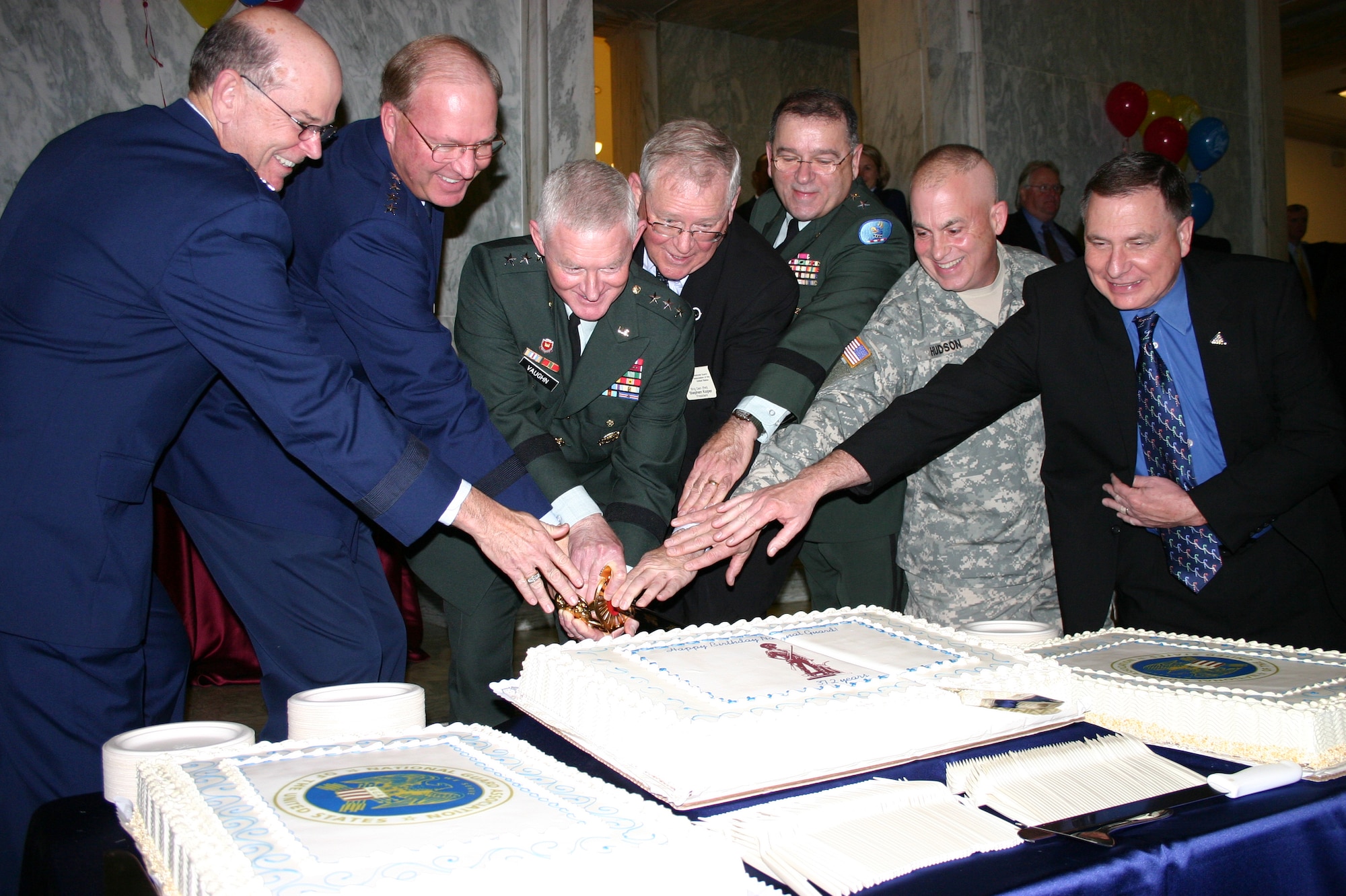 Maj. Gen. Emmett R. Titshaw Jr., Gen. Craig R. McKinley, Army Lt. Gen. Clyde A. Vaughn, retired Brig. Gen. Stephen M. Koper, Army Maj. Gen. Francis D. Vavala, Army Command Sgt. Maj. David Hudson and retired Army Sgt. Major Frank Yoakum cut a cake to celebrate the 372nd birthday of the National Guard Dec. 10 at the Rayburn House Office Building in Washington, D.C. General Titshaw is the acting director of the Air National Guard. General McKinley is the chief of the National Guard Bureau. General Vaughn is the director of the Army National Guard. General Koper is the president of the National Guard Association of the United States. General Vavala is the Delaware adjutant general and president of the Adjutants General Association of the United States. Command Sgt. Maj. Hudson is the senior enlisted adviser to the NGB chief; and Sgt. Maj. Yoakum is the legislative director of the Enlisted Association of the National Guard of the United States. (U.S. Air Force photo/Richard Arnold)